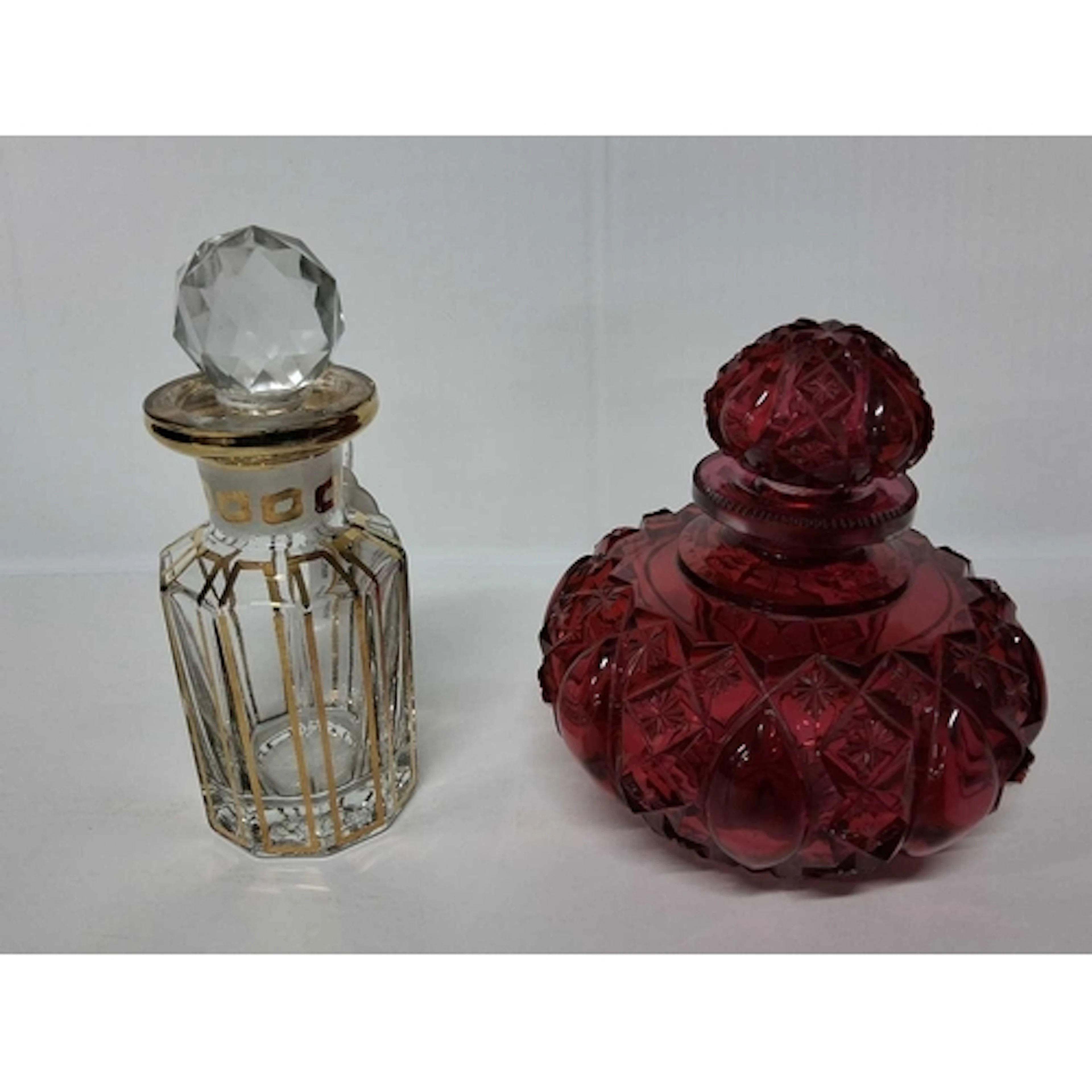 TWO GLASS SCENT BOTTLES, comprising a ruby glass scent bottl...