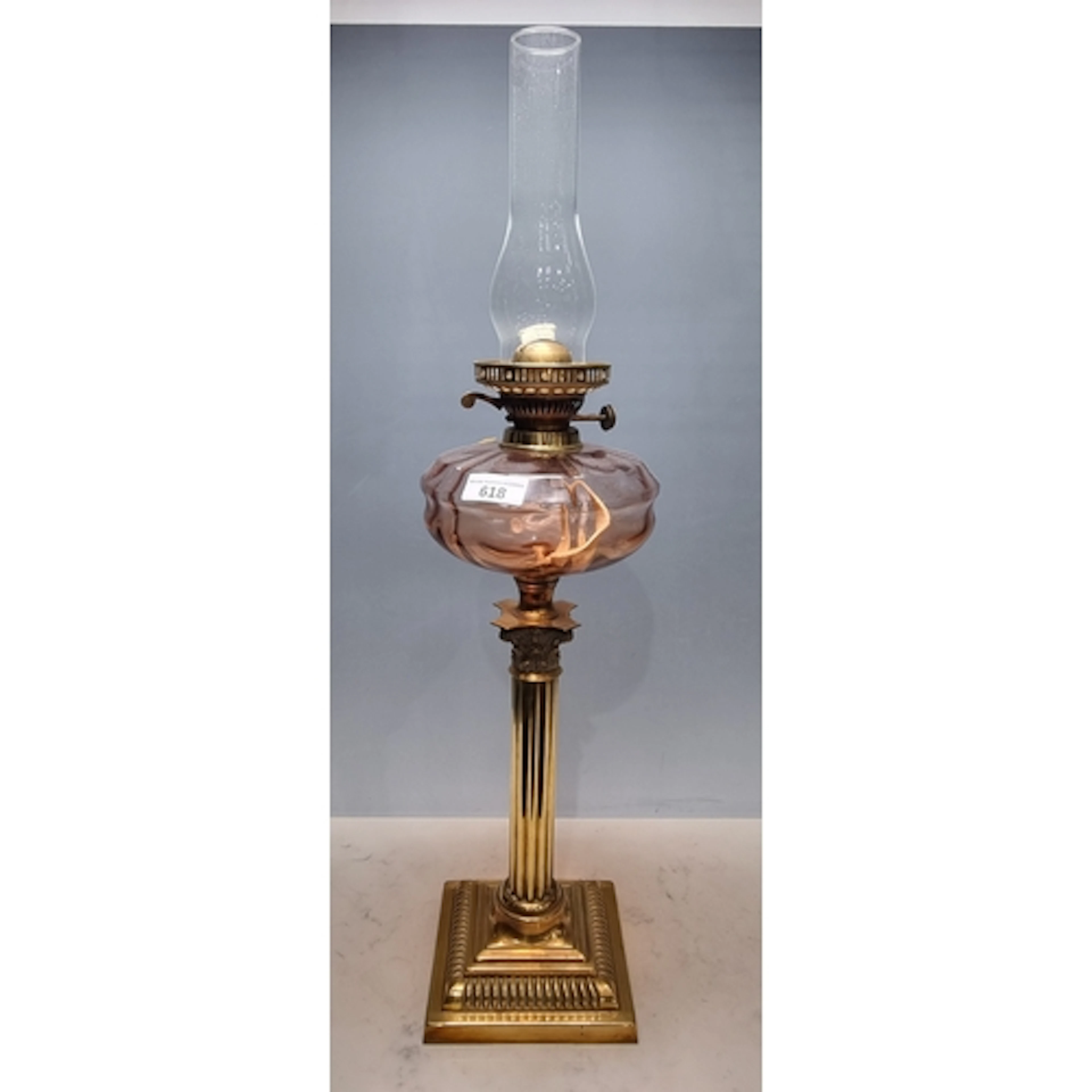 A Victorian brass Oil Lamp with amber coloured glass reservo...