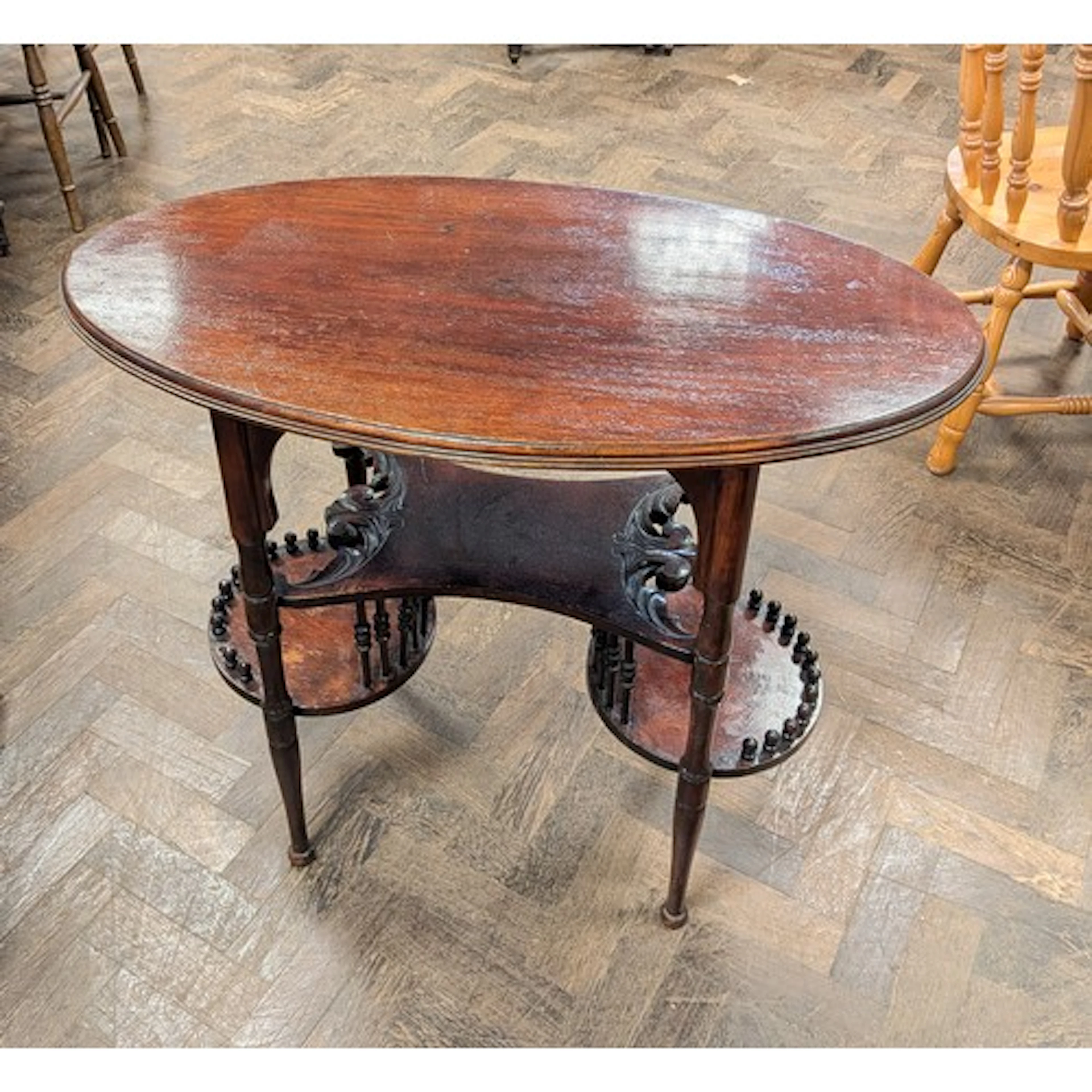 An Edwardian oval mahogany occasional table with unusual sha...