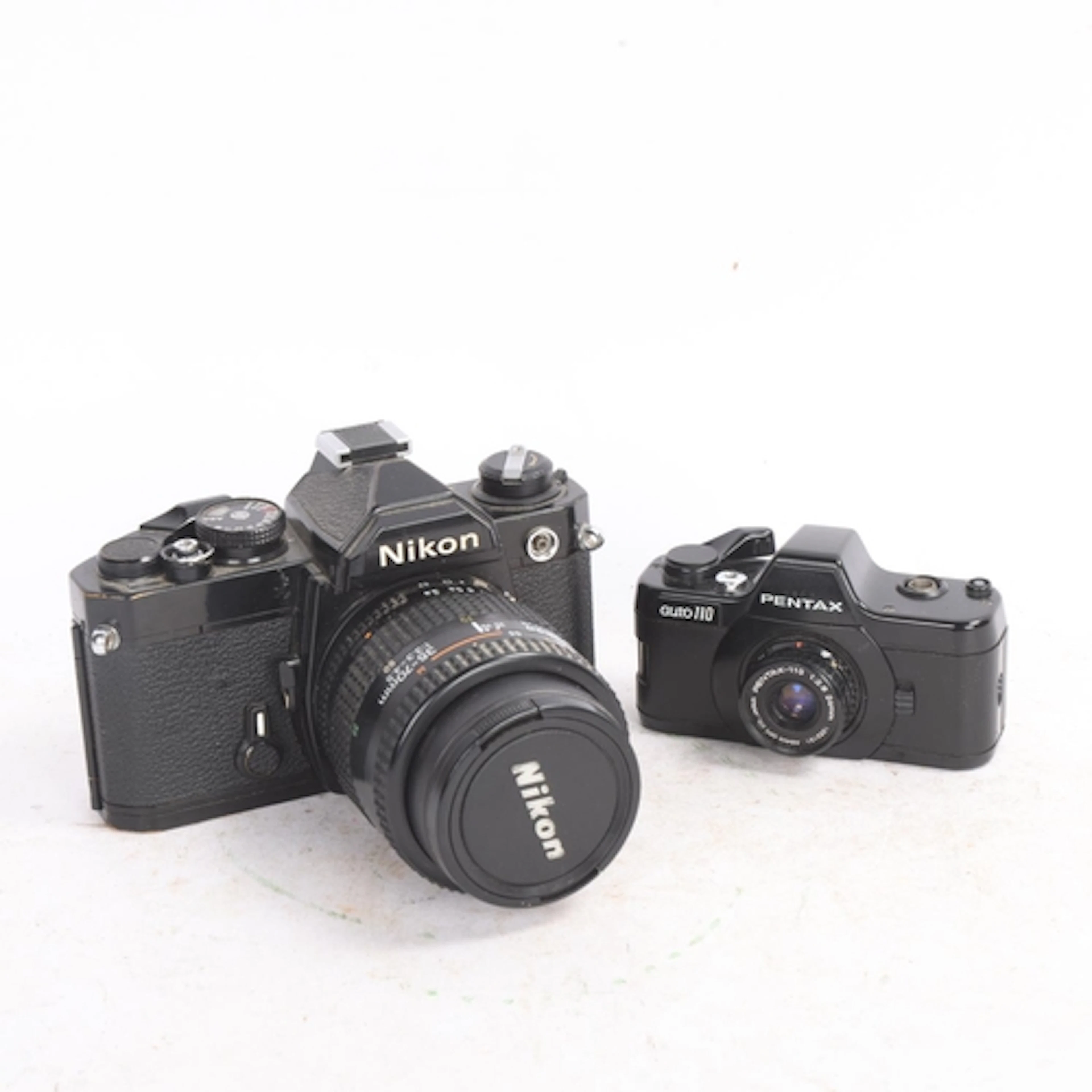 A vintage Nikon FM 35mm camera with 35-70mm AF Nikkor lens, ...