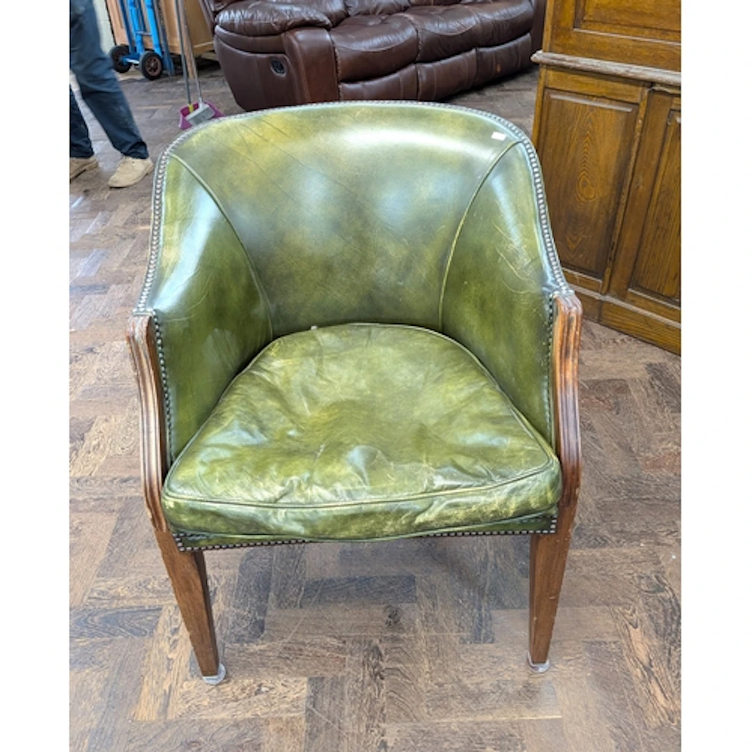 A mahogany framed green leather tub shaped office chair