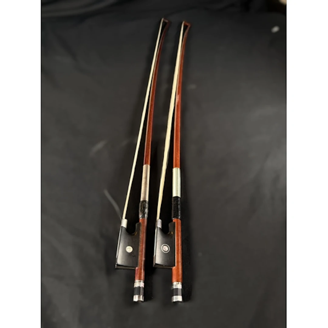 Two 20th century finely made silver mounted violin bows with...