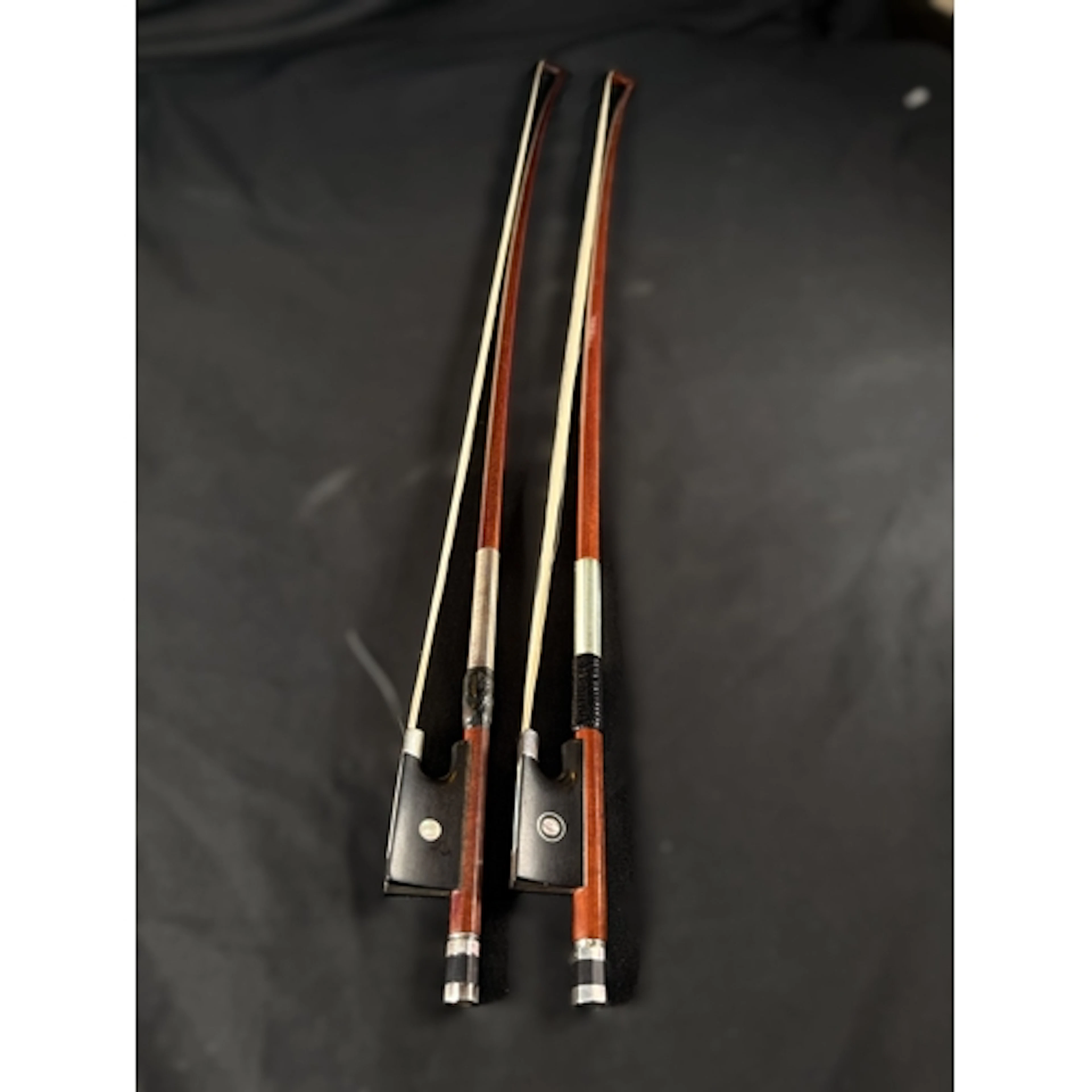 Two 20th century finely made silver mounted violin bows with...