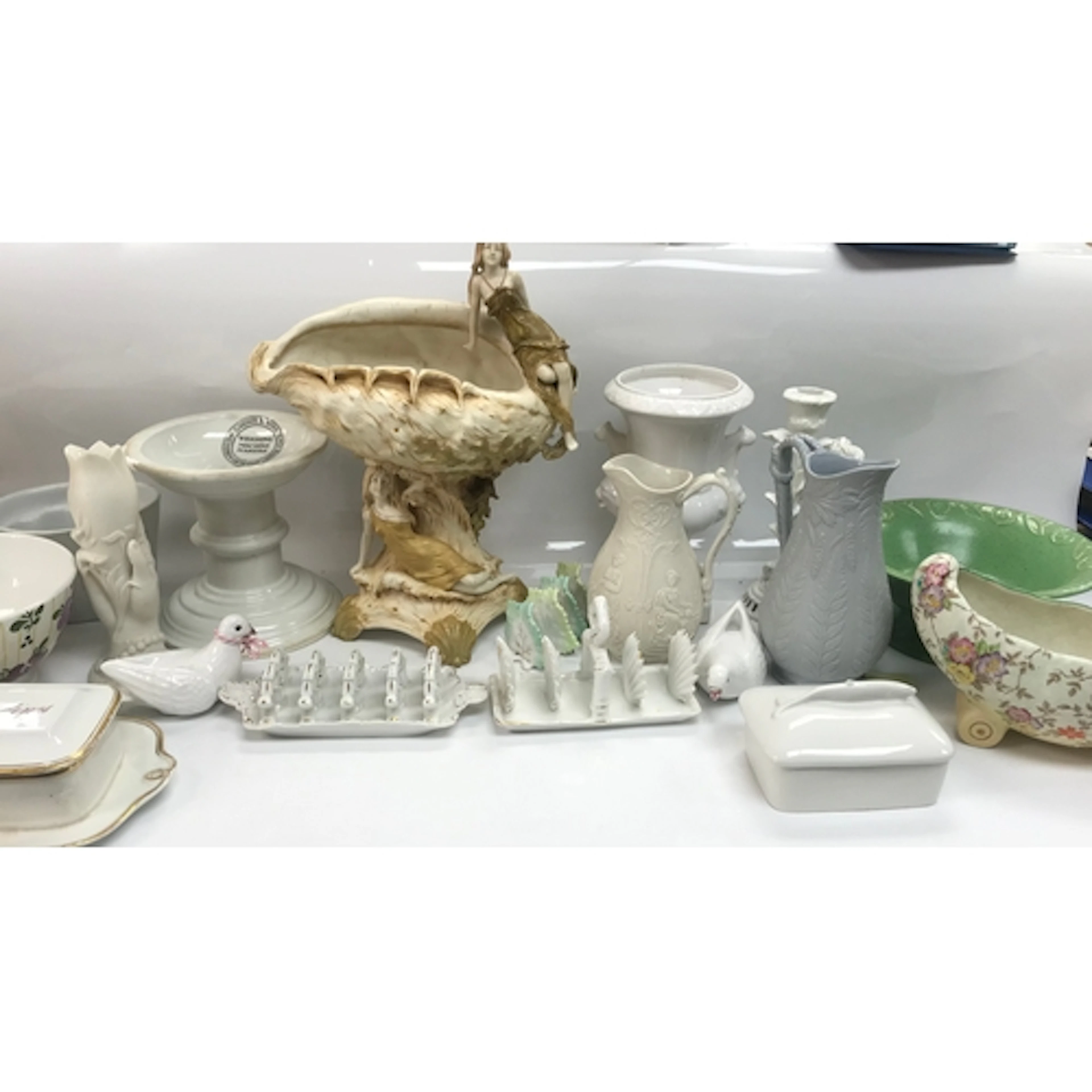 An art nouveau centrepiece alongside an assortment of antiqu...