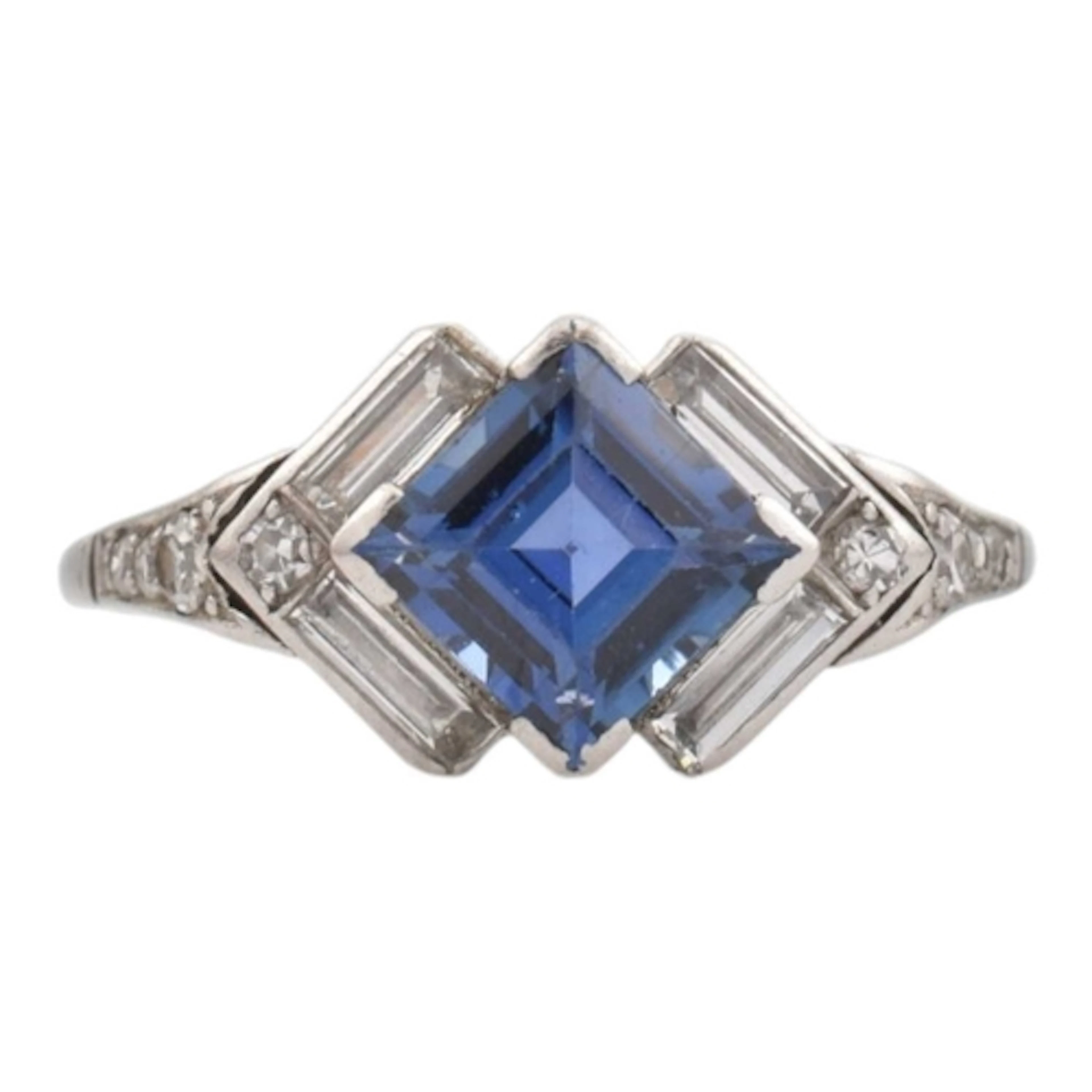 An Art Deco gold, platinum, sapphire and diamond ring. The r...