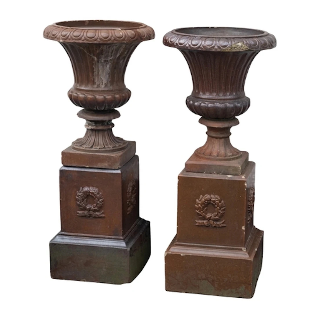A pair of glazed stoneware garden urns on plinths, early 20t...