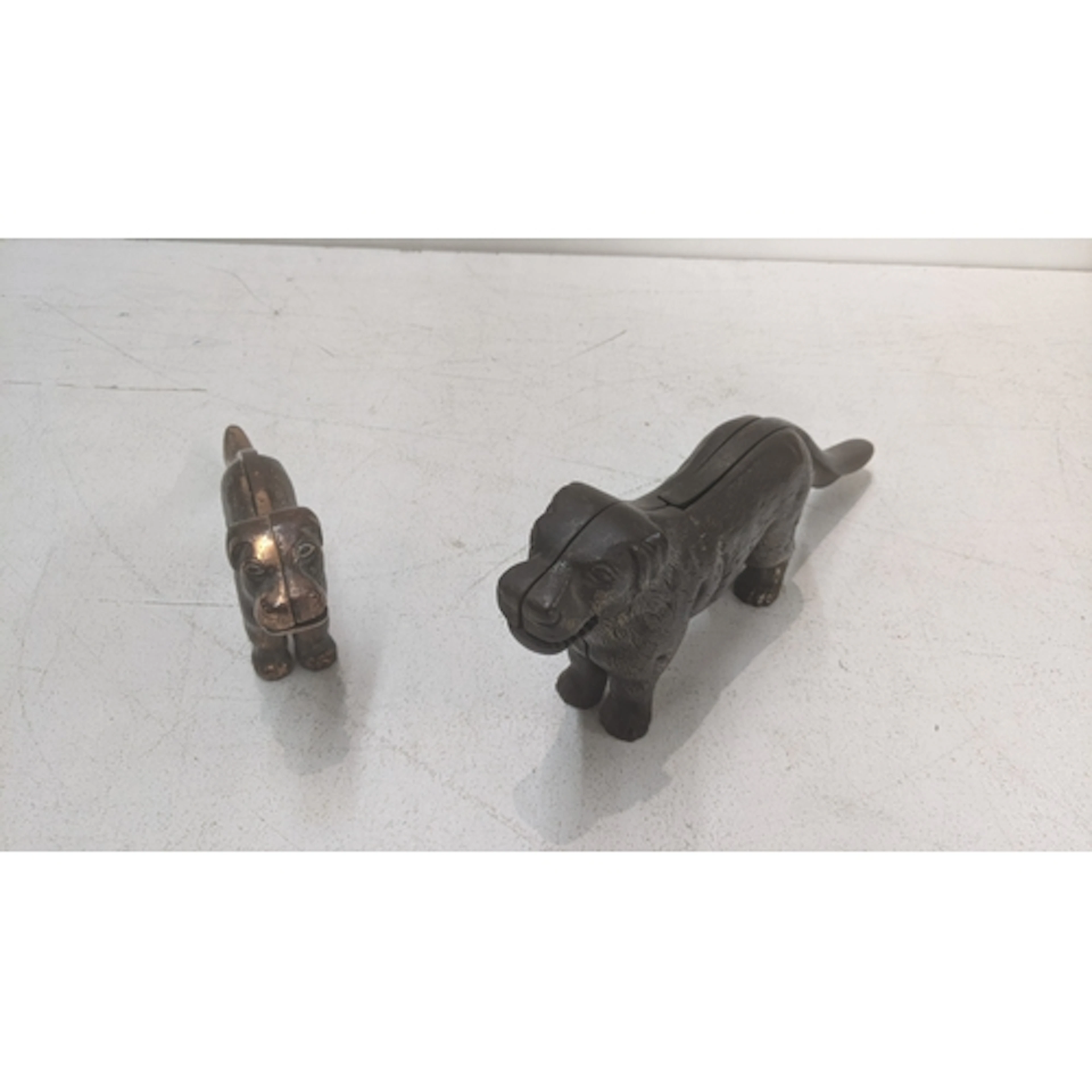 Two cast metal nut crackers fashioned as dogs Location: If t...