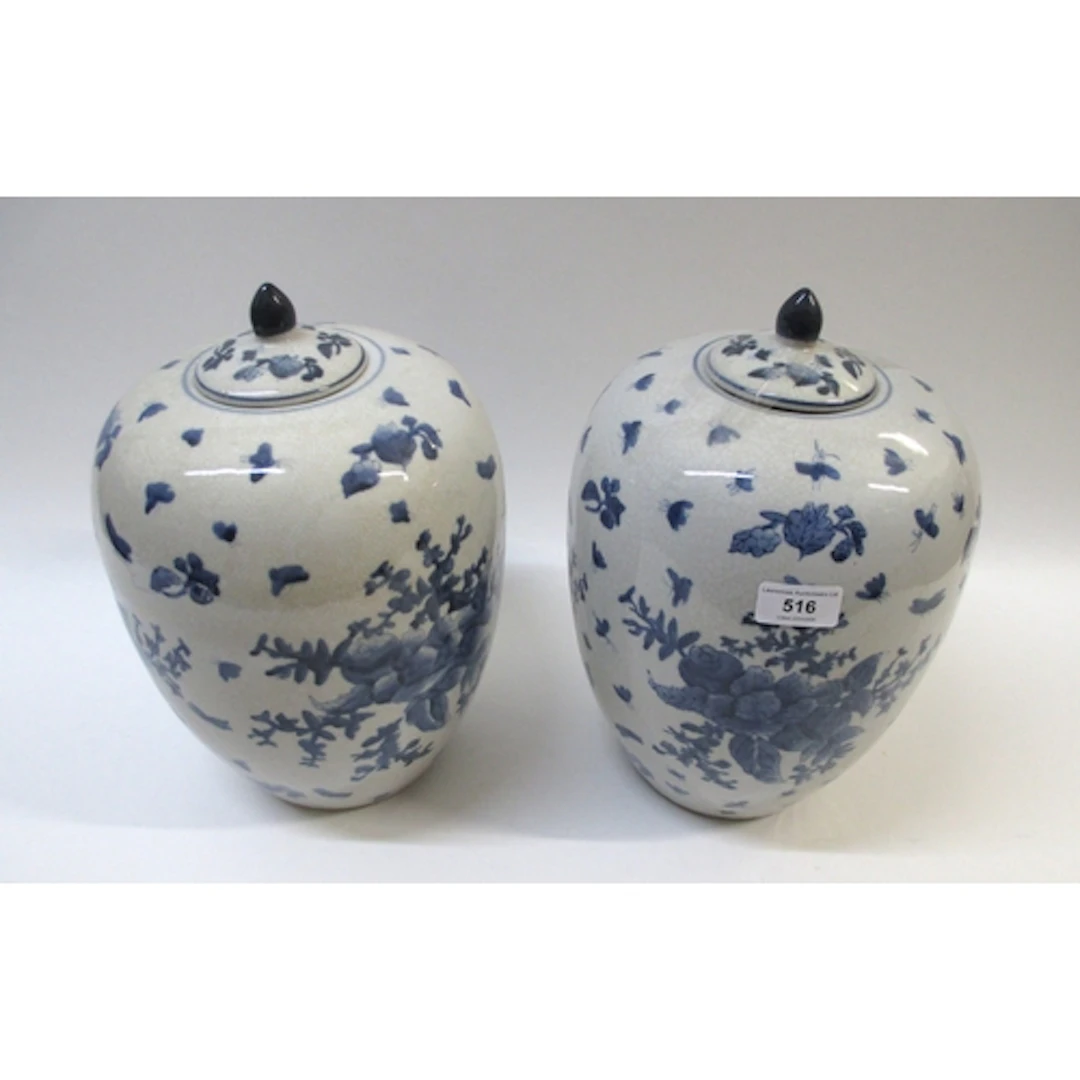 Pair of blue and white floral and insect decorated jars with...