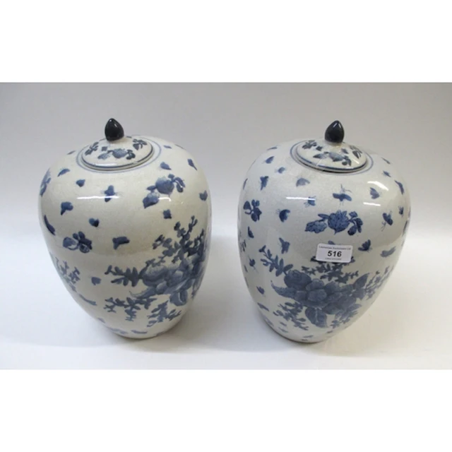 Pair of blue and white floral and insect decorated jars with...