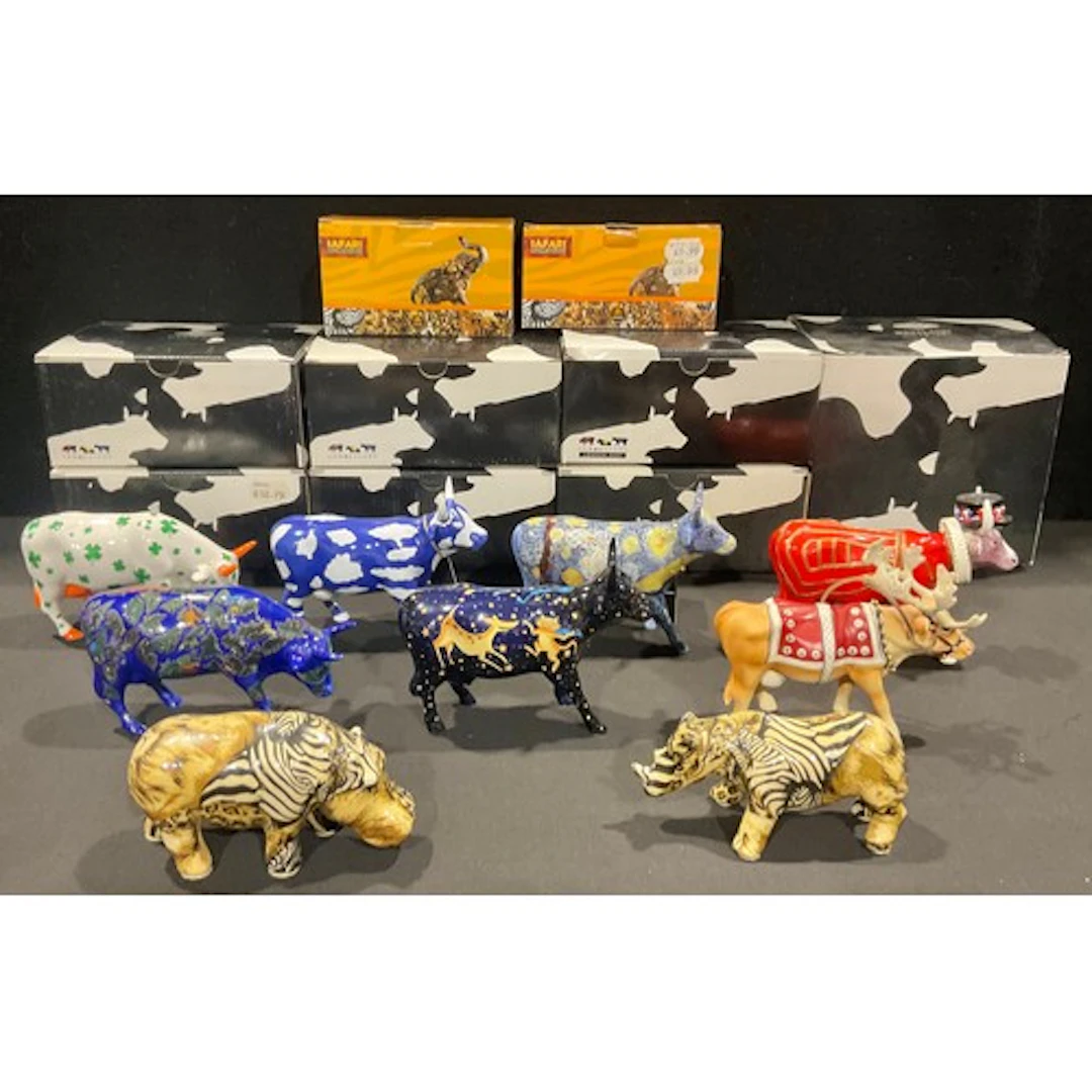 A collection of seven ceramic and resin Cow Parade models, i...