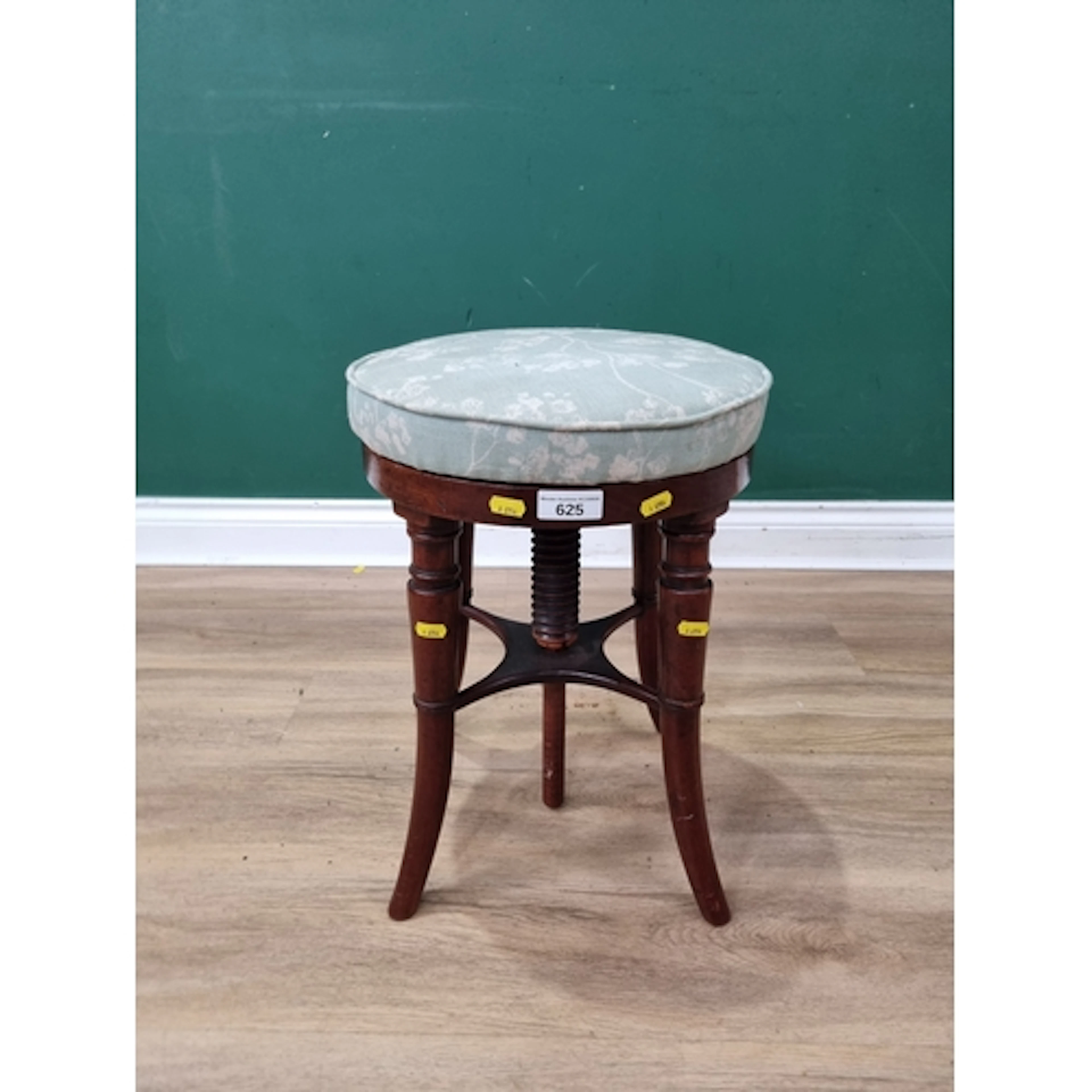 A mahogany swivel-action Piano Stool with four splayed, turn...