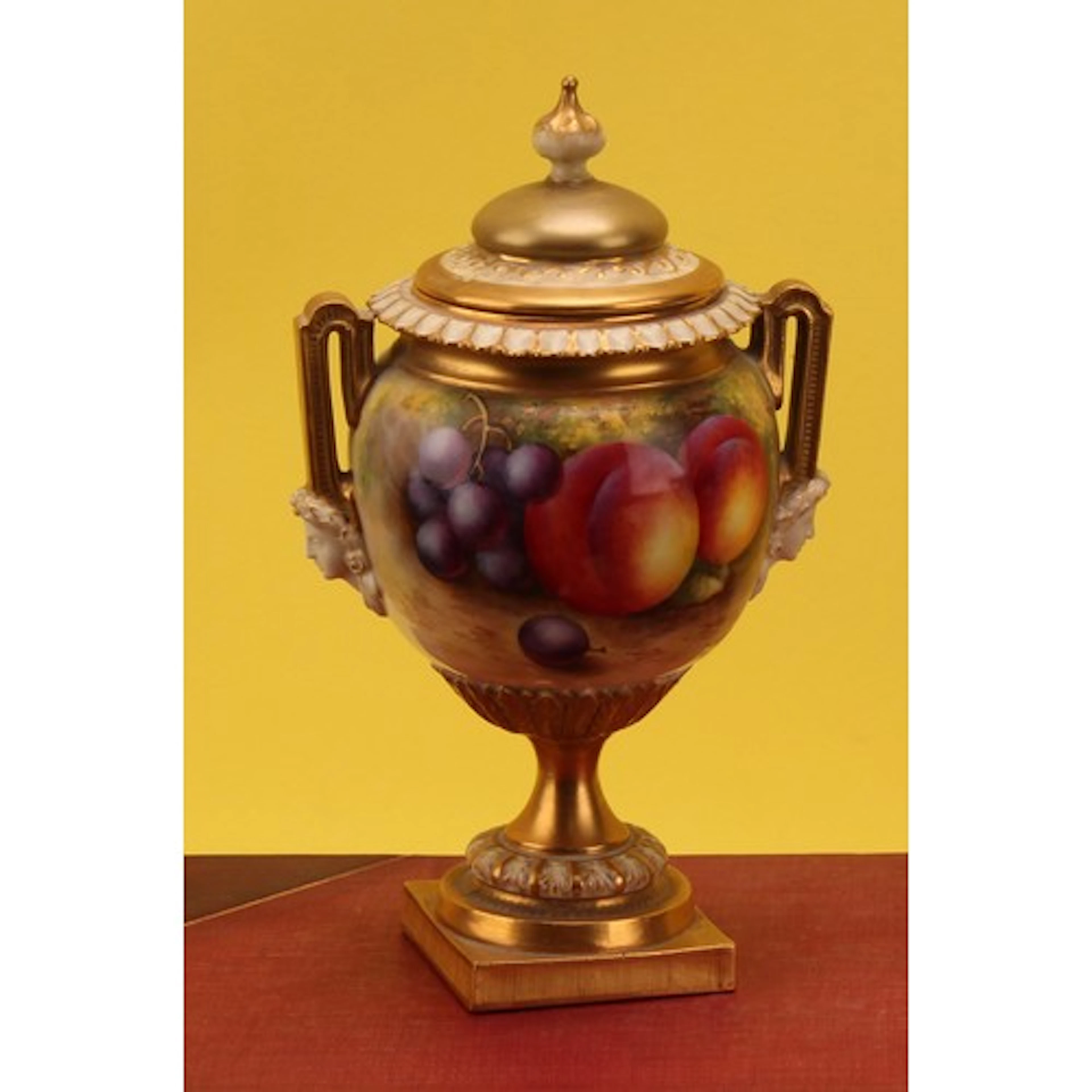 A Royal Worcester two handled pedestal vase and cover, paint...