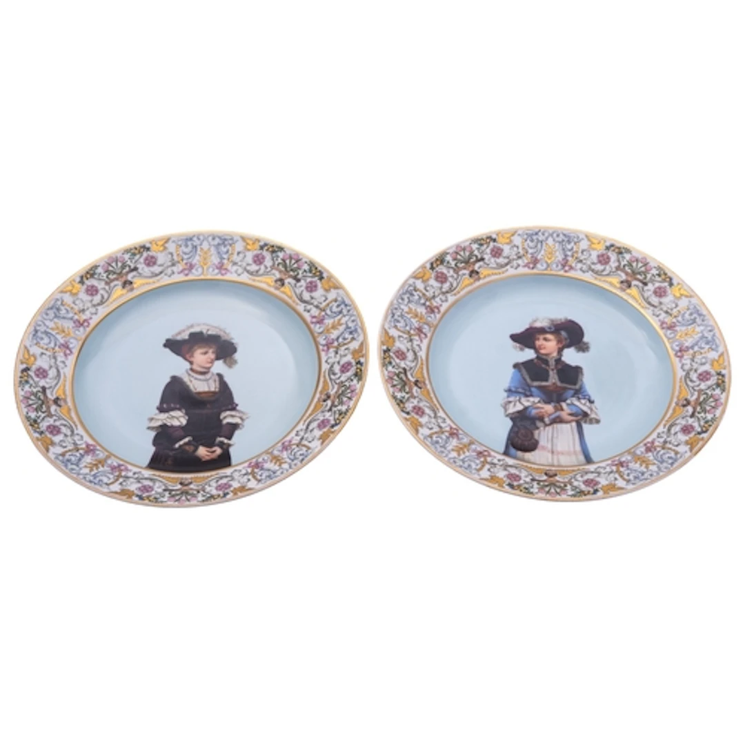 A pair of Continental porcelain plates each decorated with a...