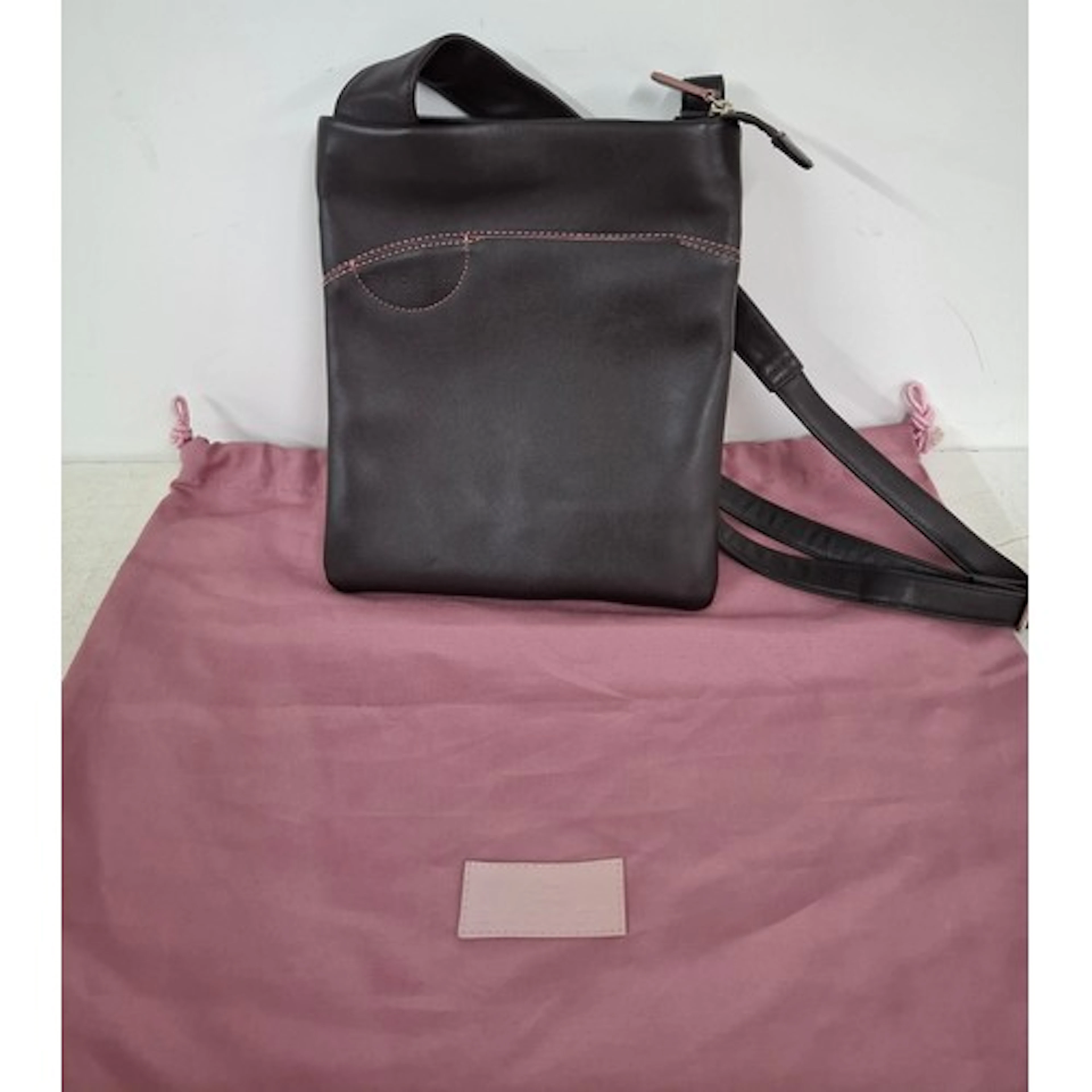 Radley- A brown leather crossover bag with pink branded dust...