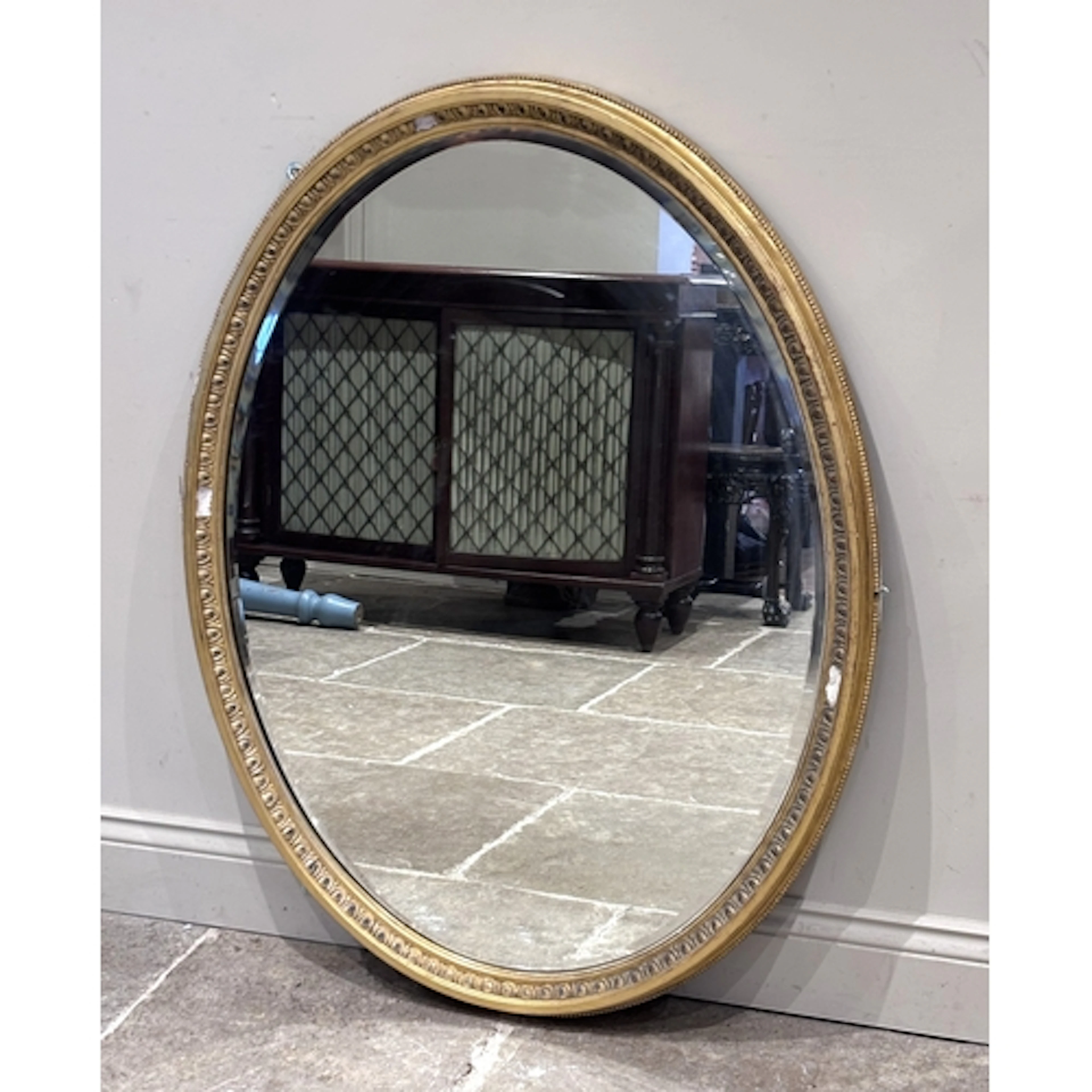 A mid-19th century giltwood and gesso oval wall mirror, the ...