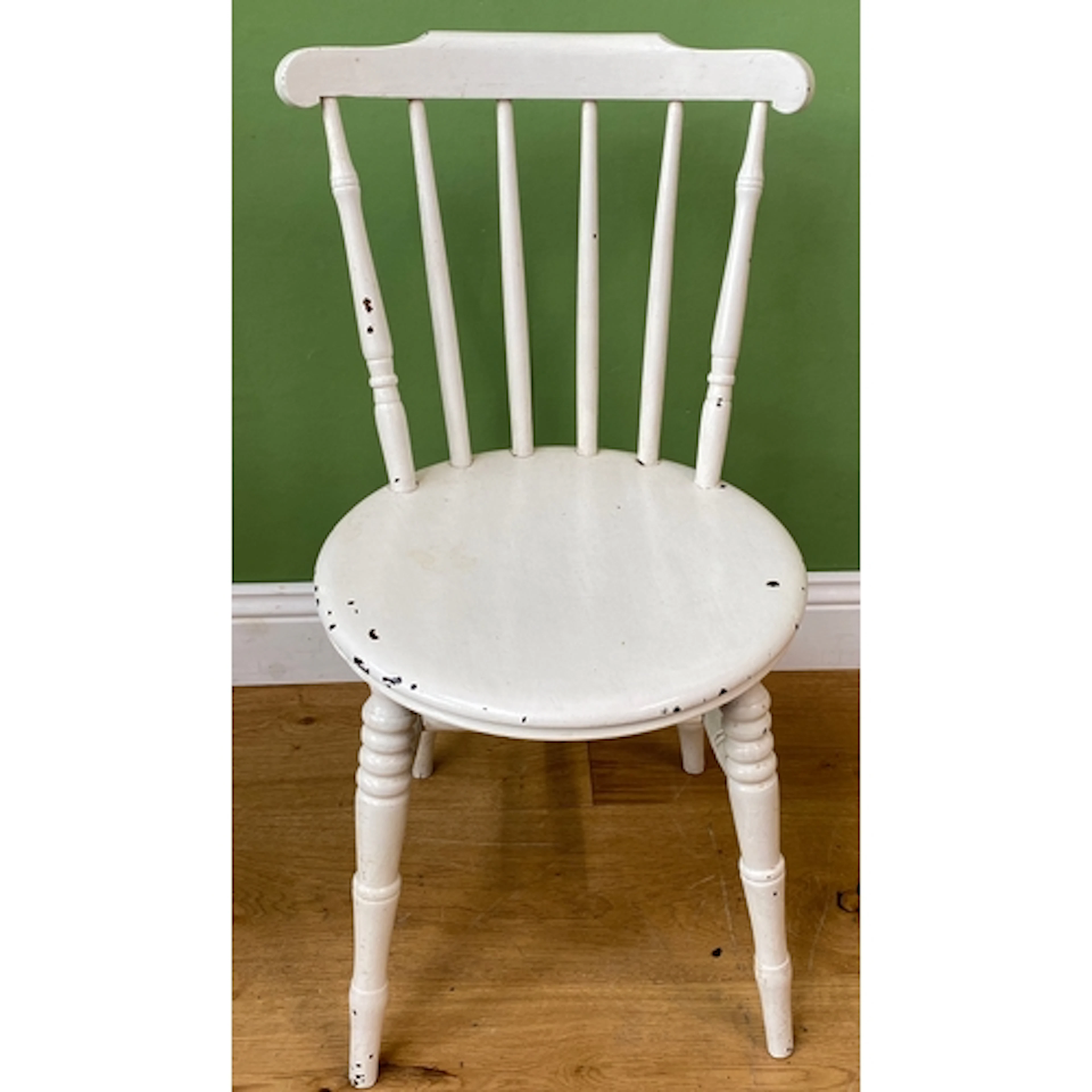 A set of three white painted Windsor side chairs with circul...