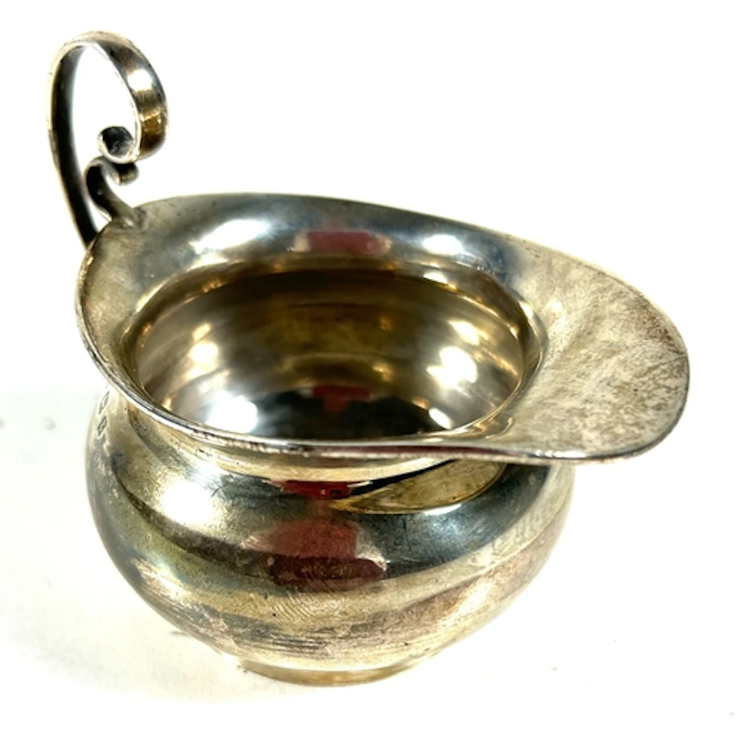 A small silver creamer/ milk jug. B'ham 1906, by T.W. Weight...