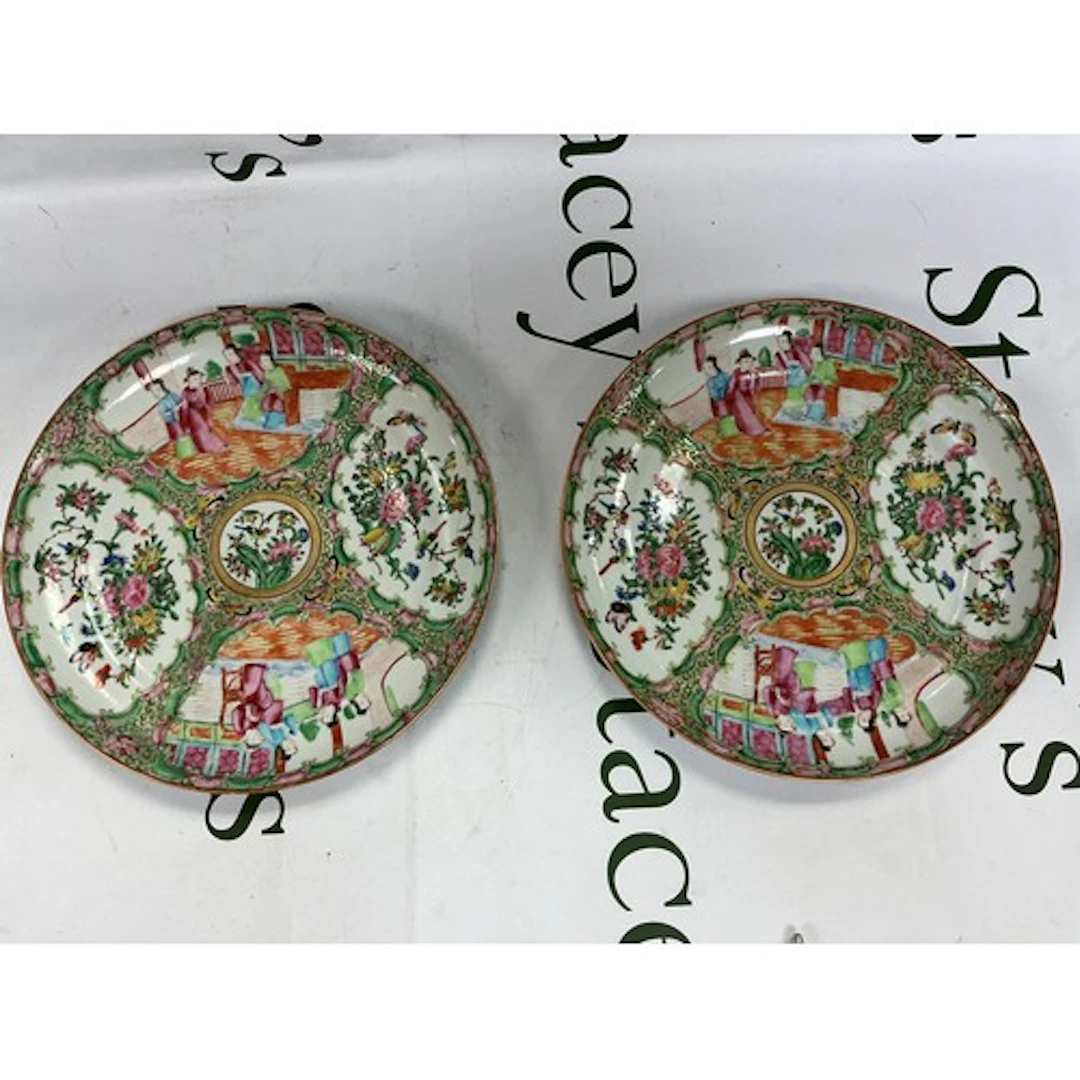 A pair of famille rose plates decorated with figures, birds ...