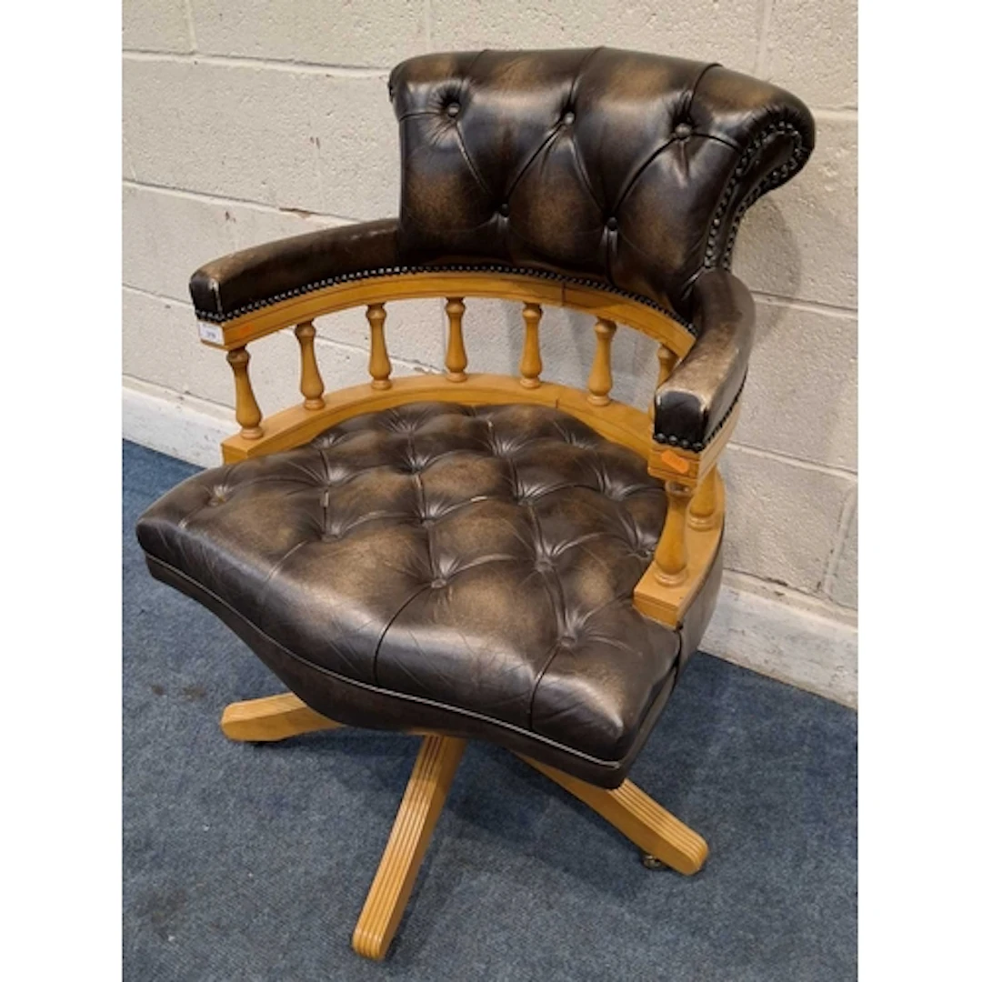 A REPRODUCTION BOW TOP SWIVEL OFFICE CHAIR, with buttoned le...