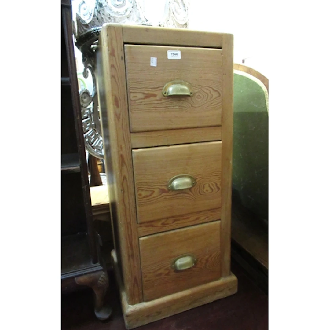 Stripped pine three drawer narrow chest, with brass cup hand...