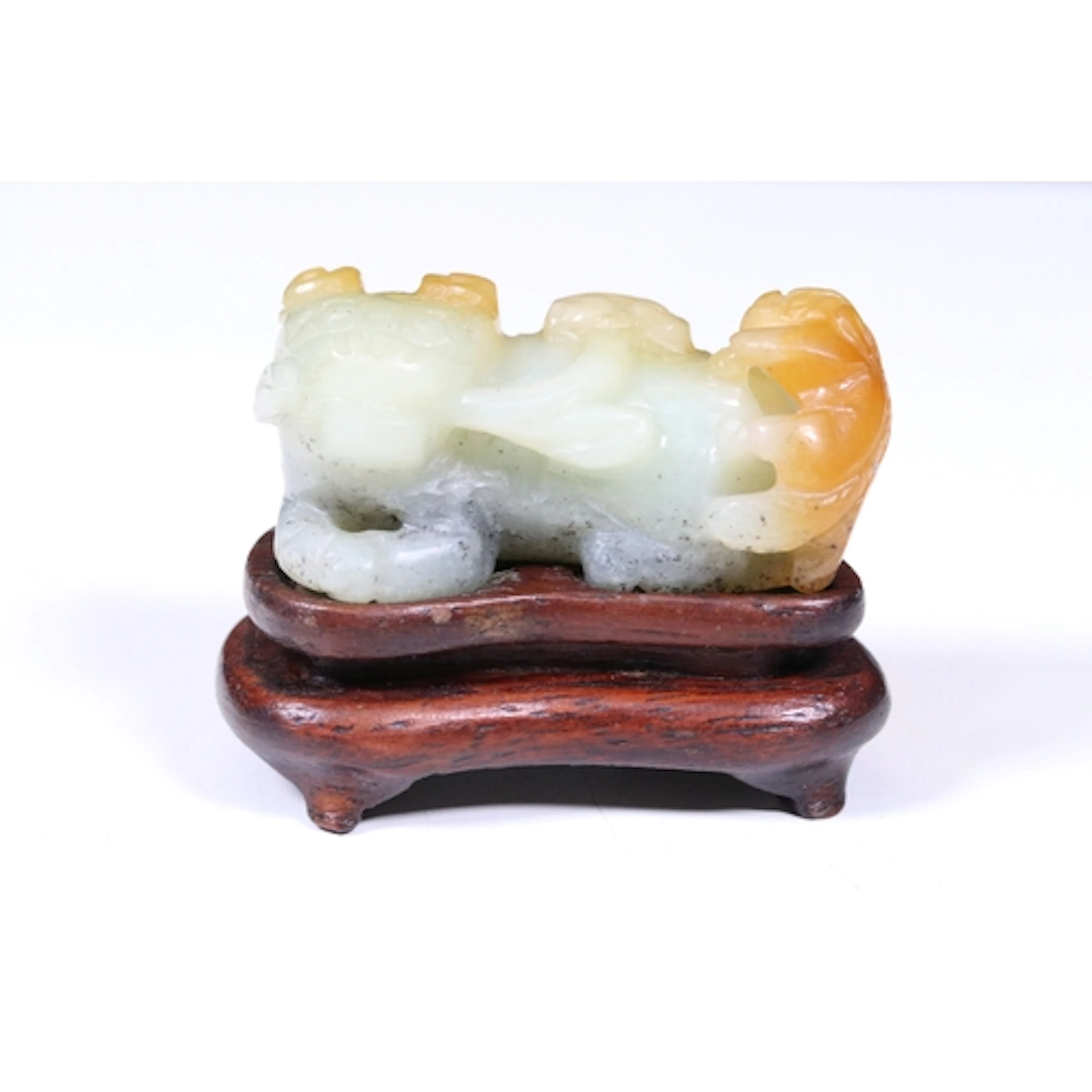 19th century carved jade recumbent lion, modelled with small...