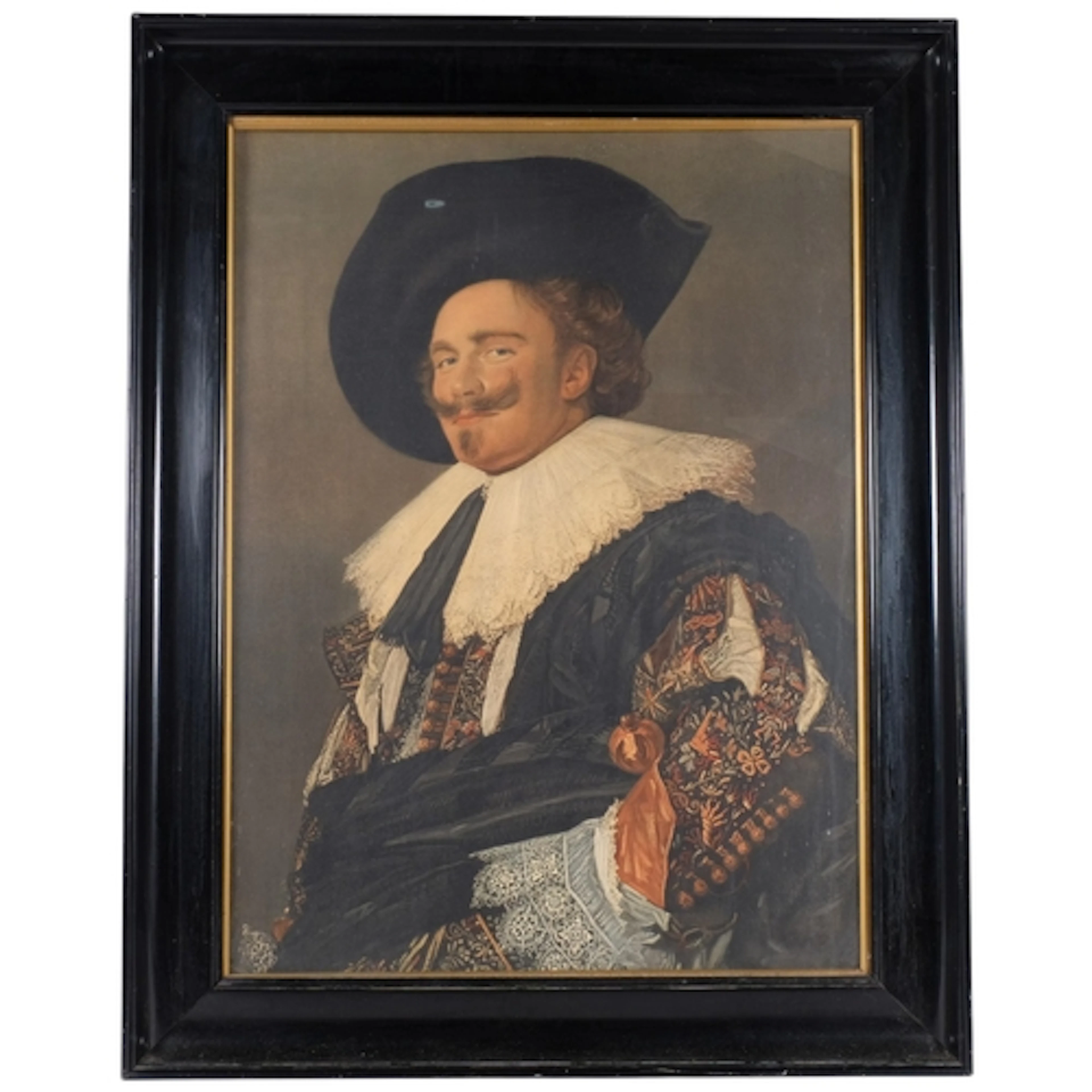 A Frans Hals print, The Laughing Cavalier, housed in ebonise...