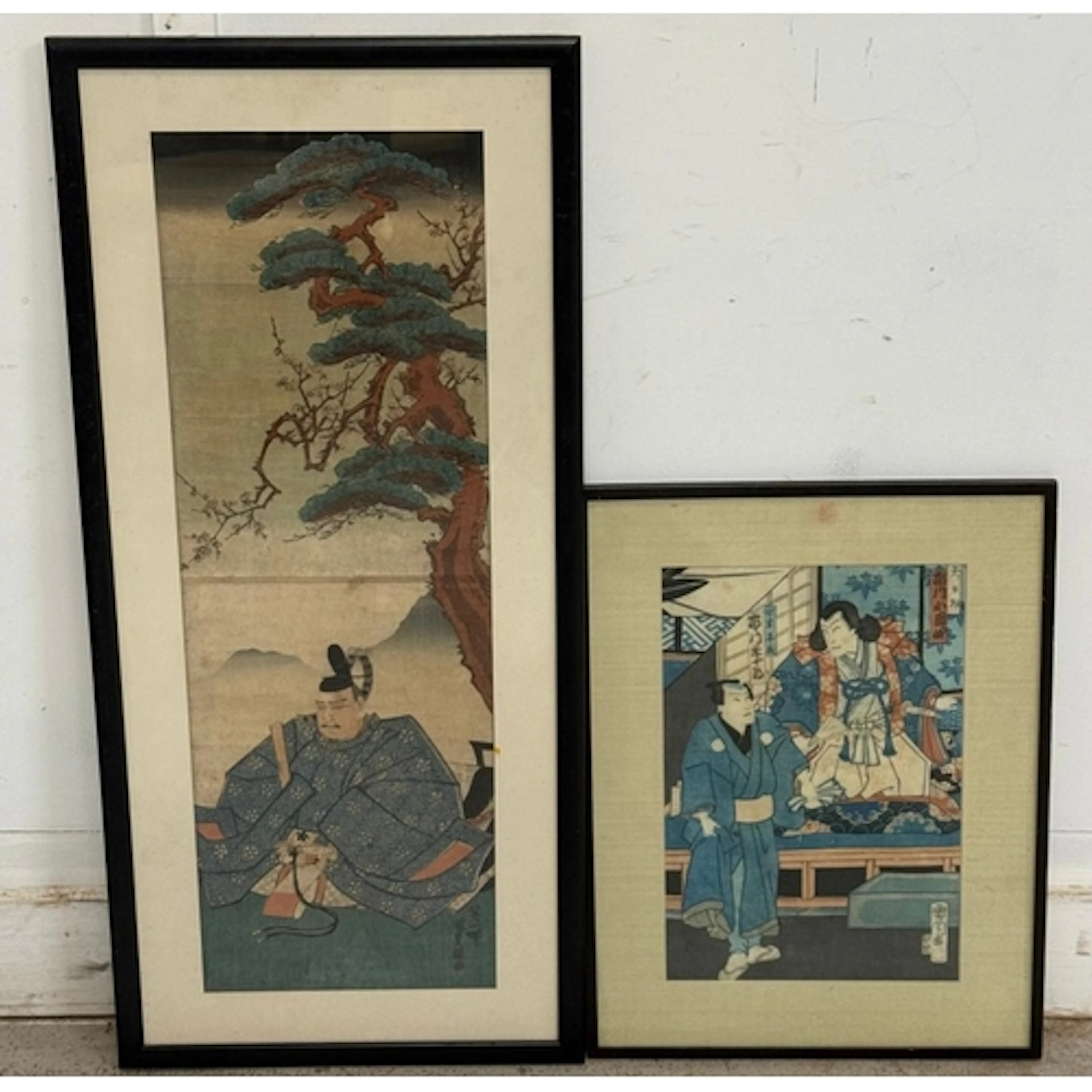 Two coloured Japanese block prints featuring traditional sce...