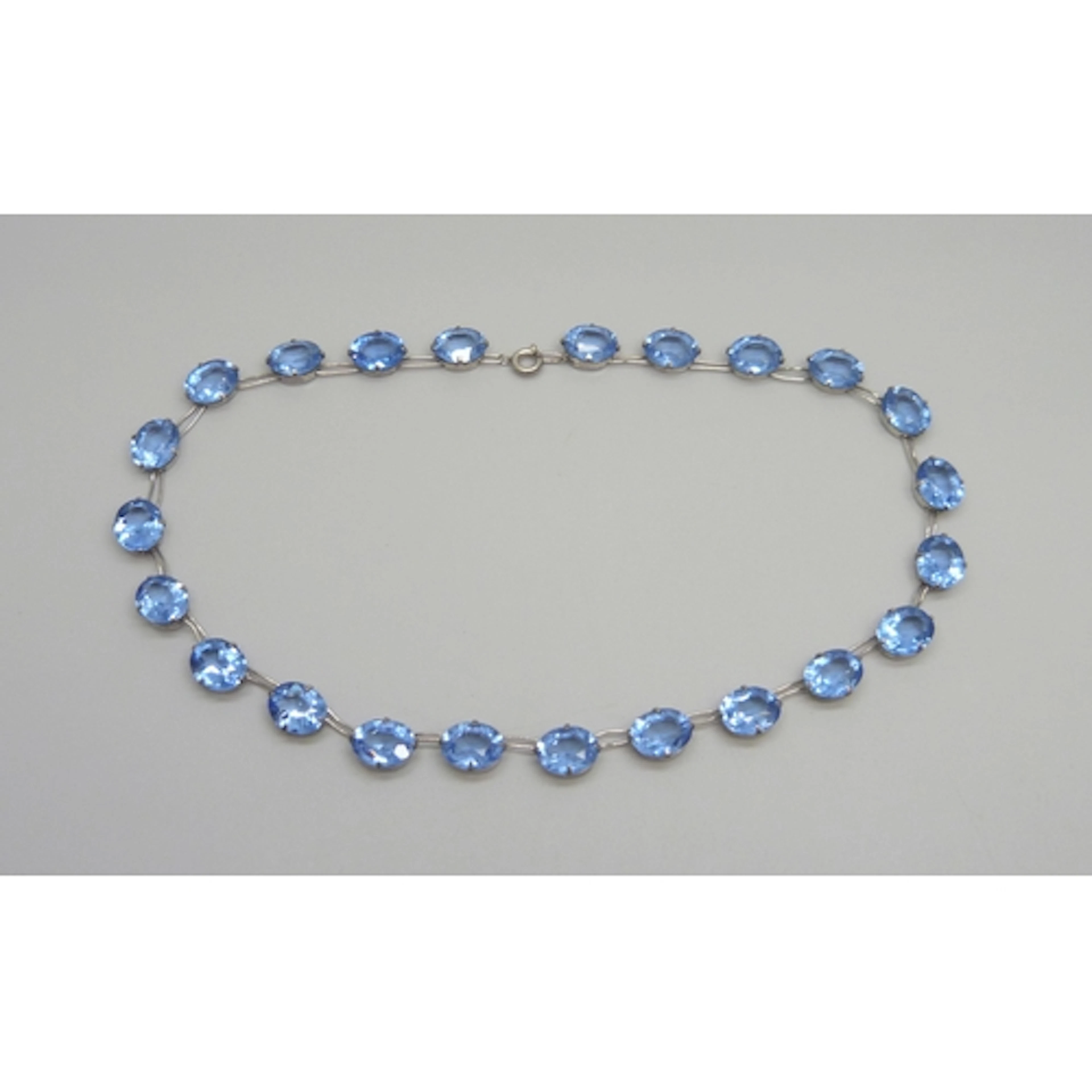An Art Deco sterling silver and blue paste stone riviera nec...