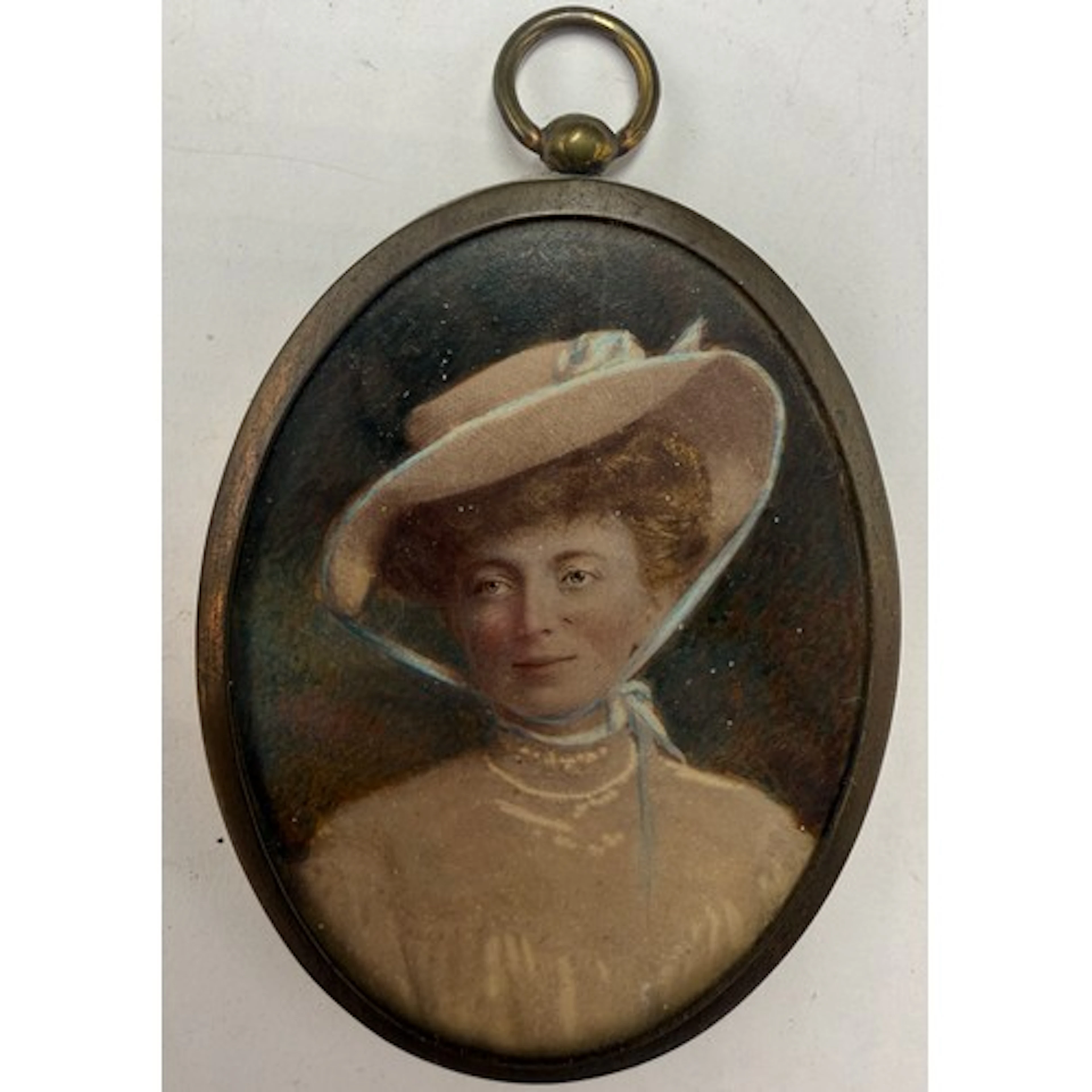 Miniature portrait on card of a lady in a high necked blouse...