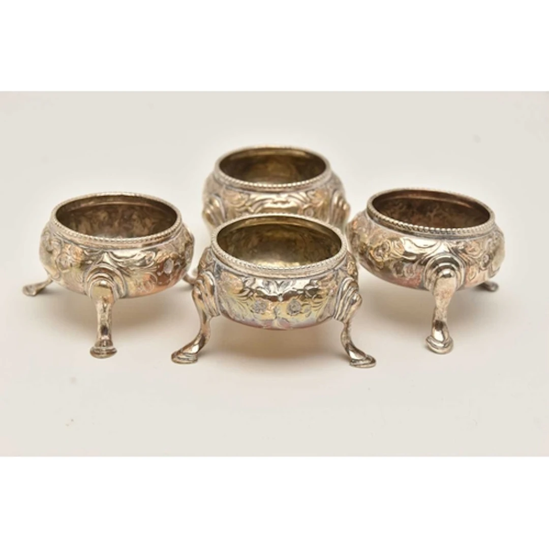 A SET OF FOUR VICTORIAN SILVER SALTS, each of a cauldron for...