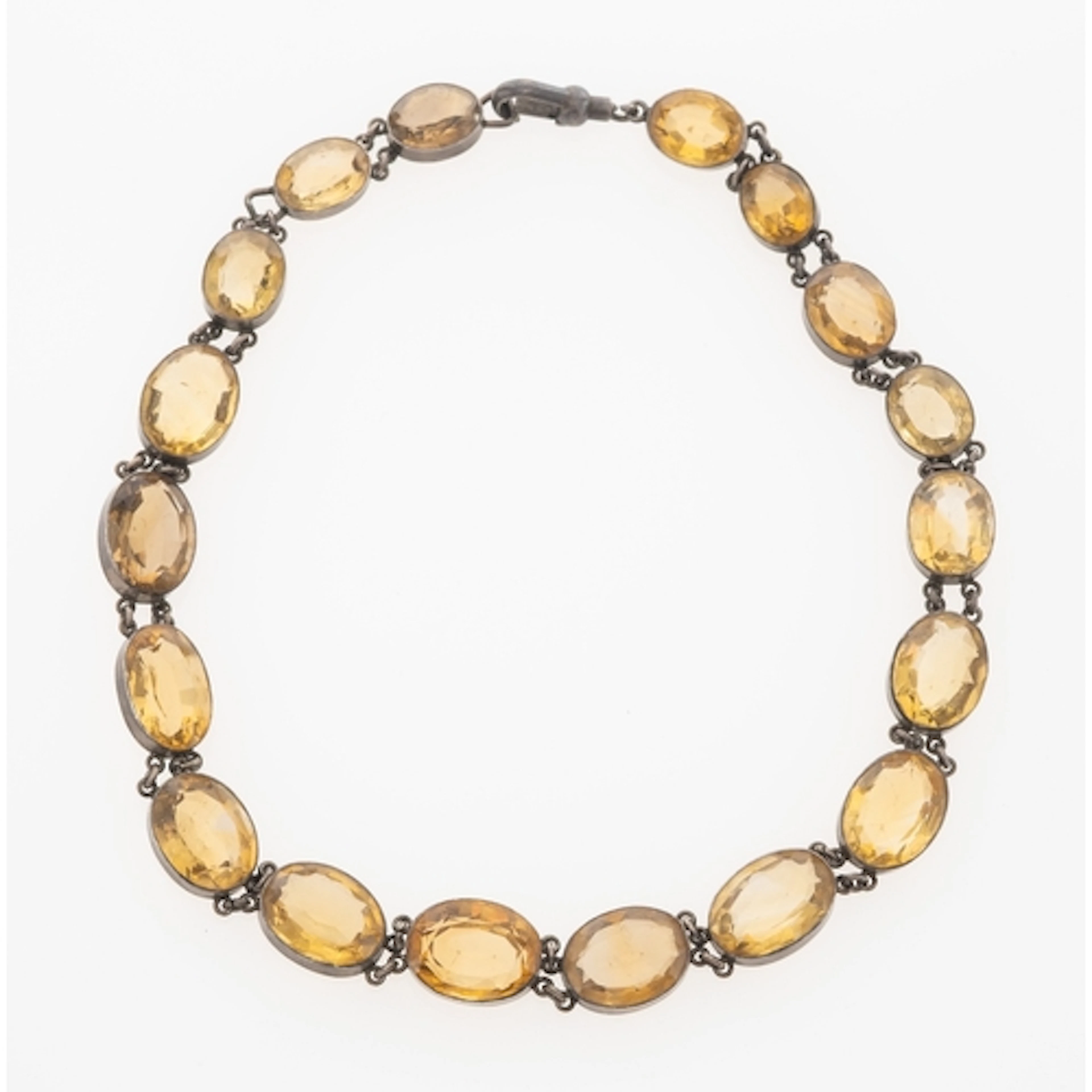 A Citrine riviere choker necklace, in white metal with oval ...