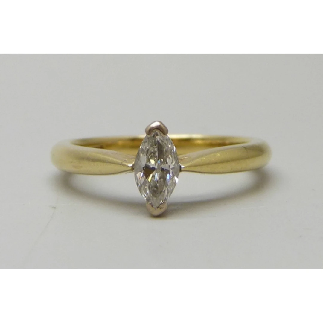 An 18ct gold marquise cut diamond solitaire ring, setting 8m...