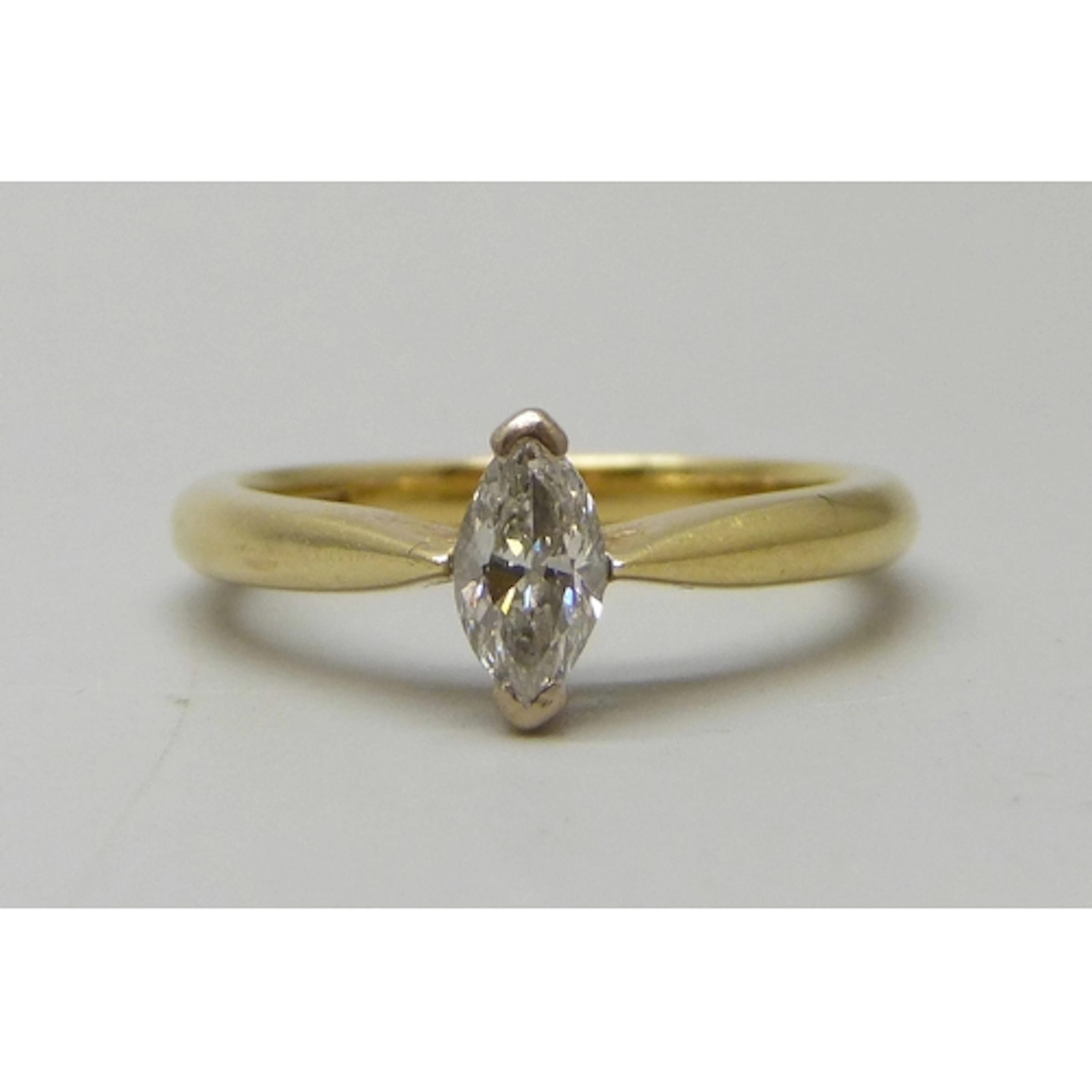 An 18ct gold marquise cut diamond solitaire ring, setting 8m...