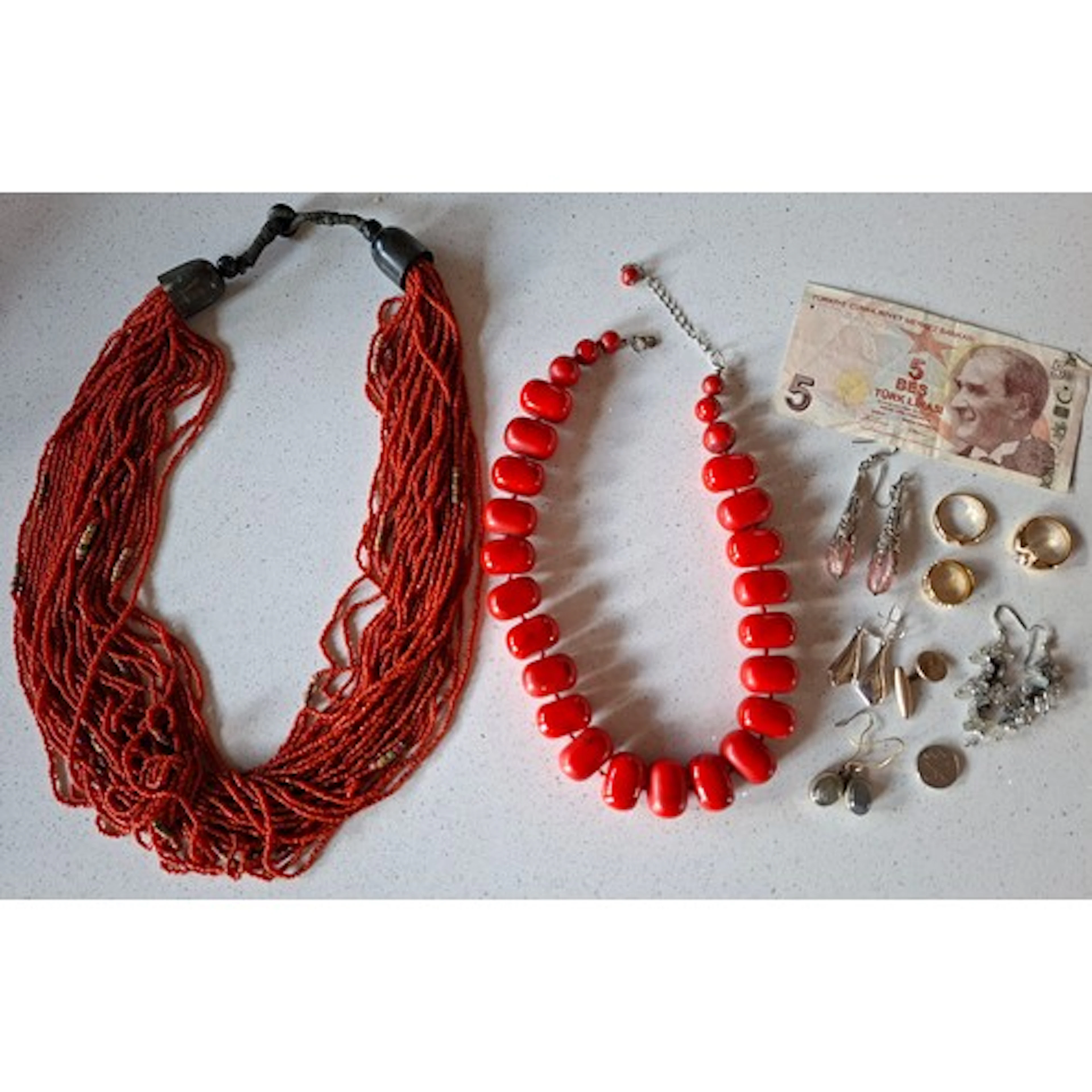 A vintage multi-strand red coral necklace, a red polished co...