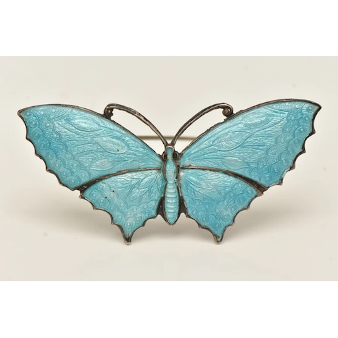 A WHITE METAL BLUE ENAMEL BUTTERFLY BROOCH, stamped 'Sterlin...