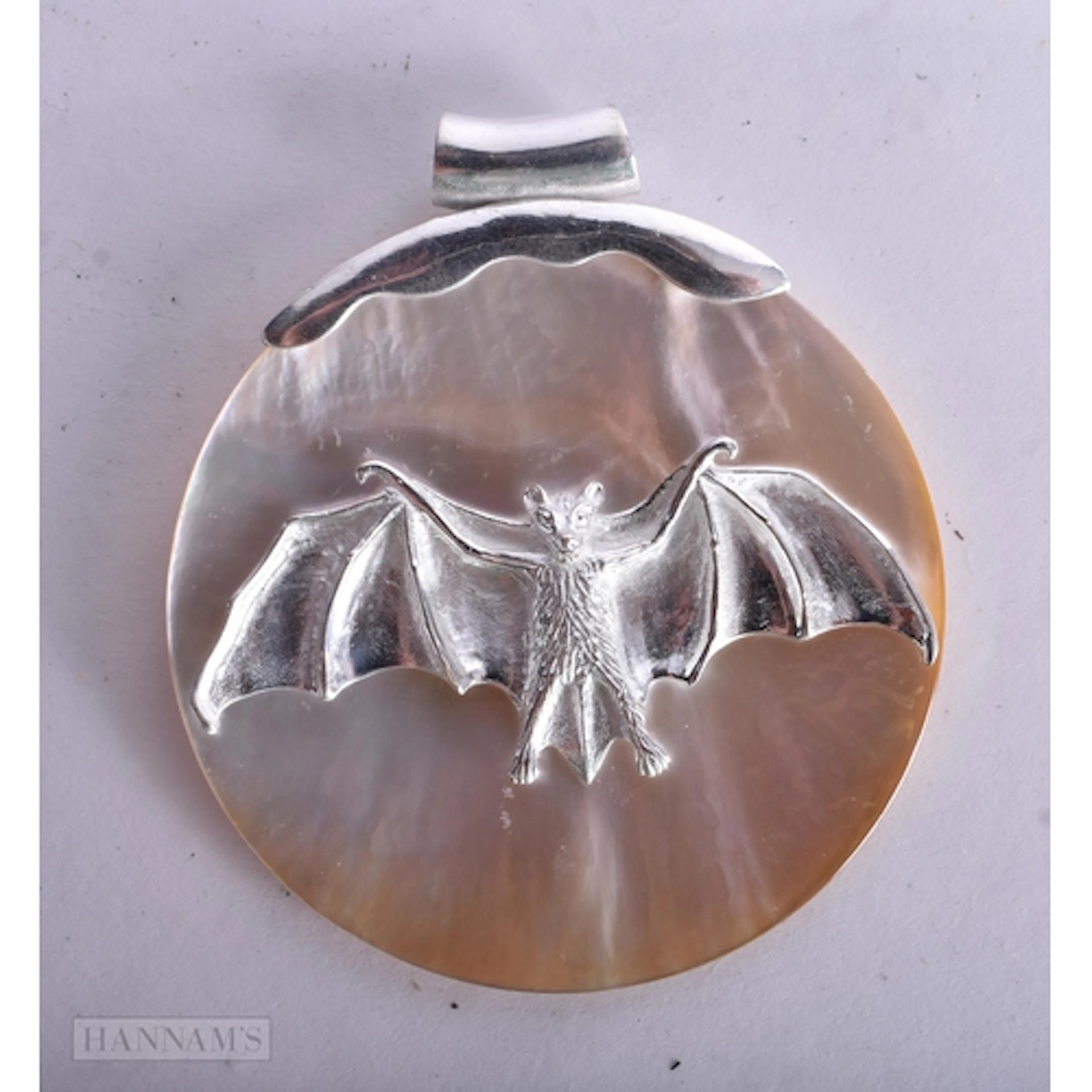 A Silver and Mother of Pearl Bat Pendant. Stamped 925. 6.7...