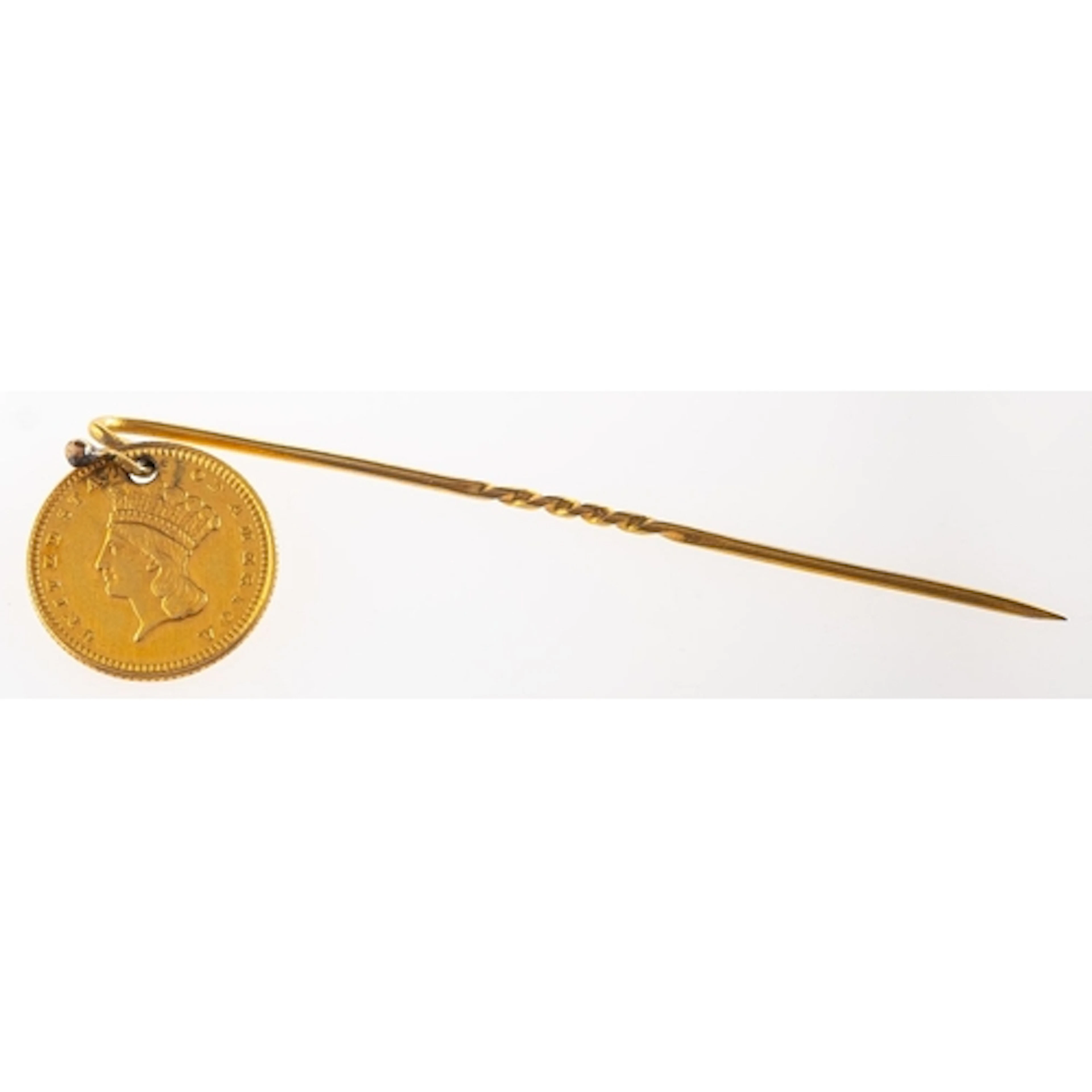 A stick pin with attached one dollar coin, the coin being a ...