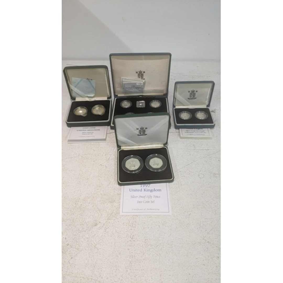 Boxed silver Royal Mint coin sets to include a fifty pence t...