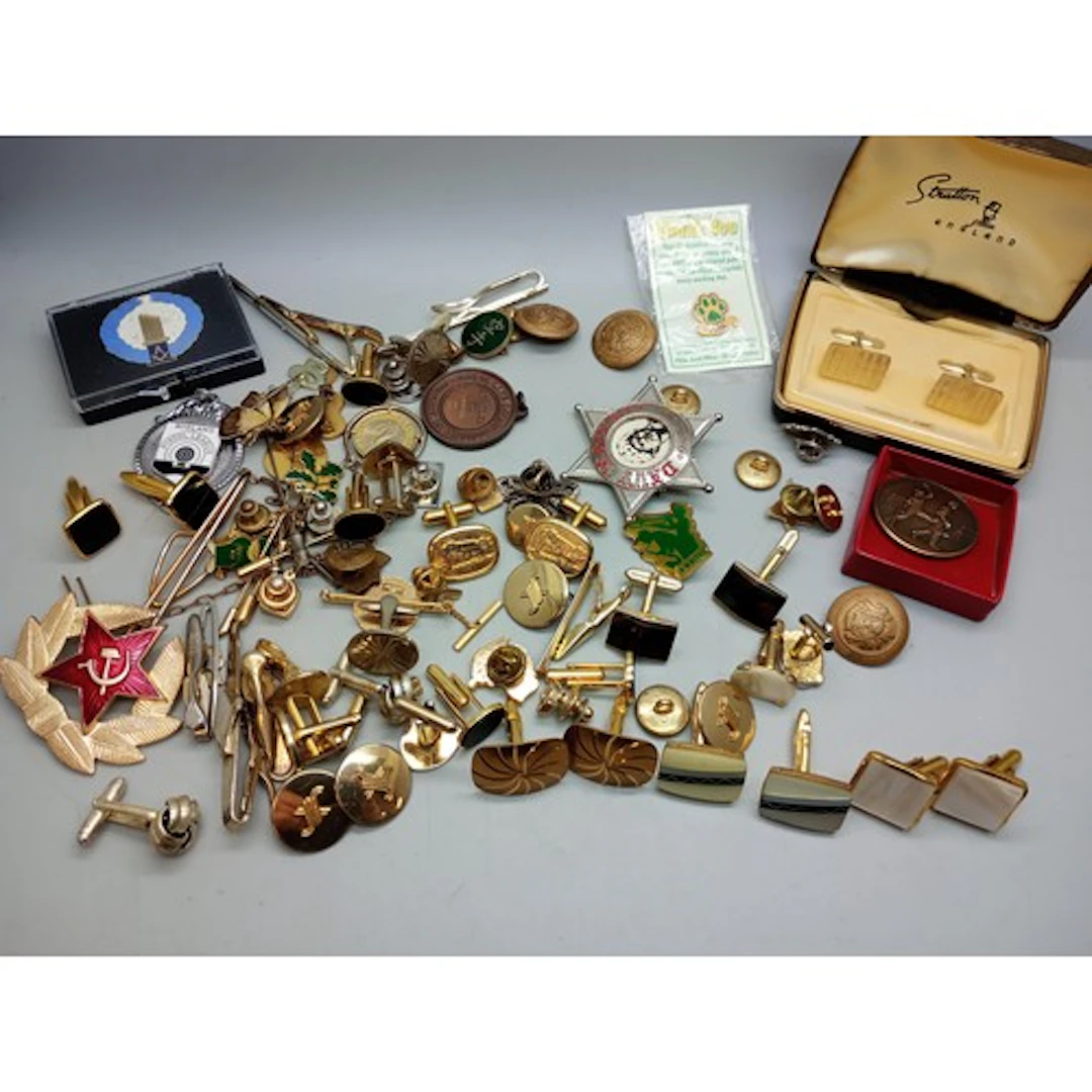 A collection of tie pins, cufflinks and buttons including St...