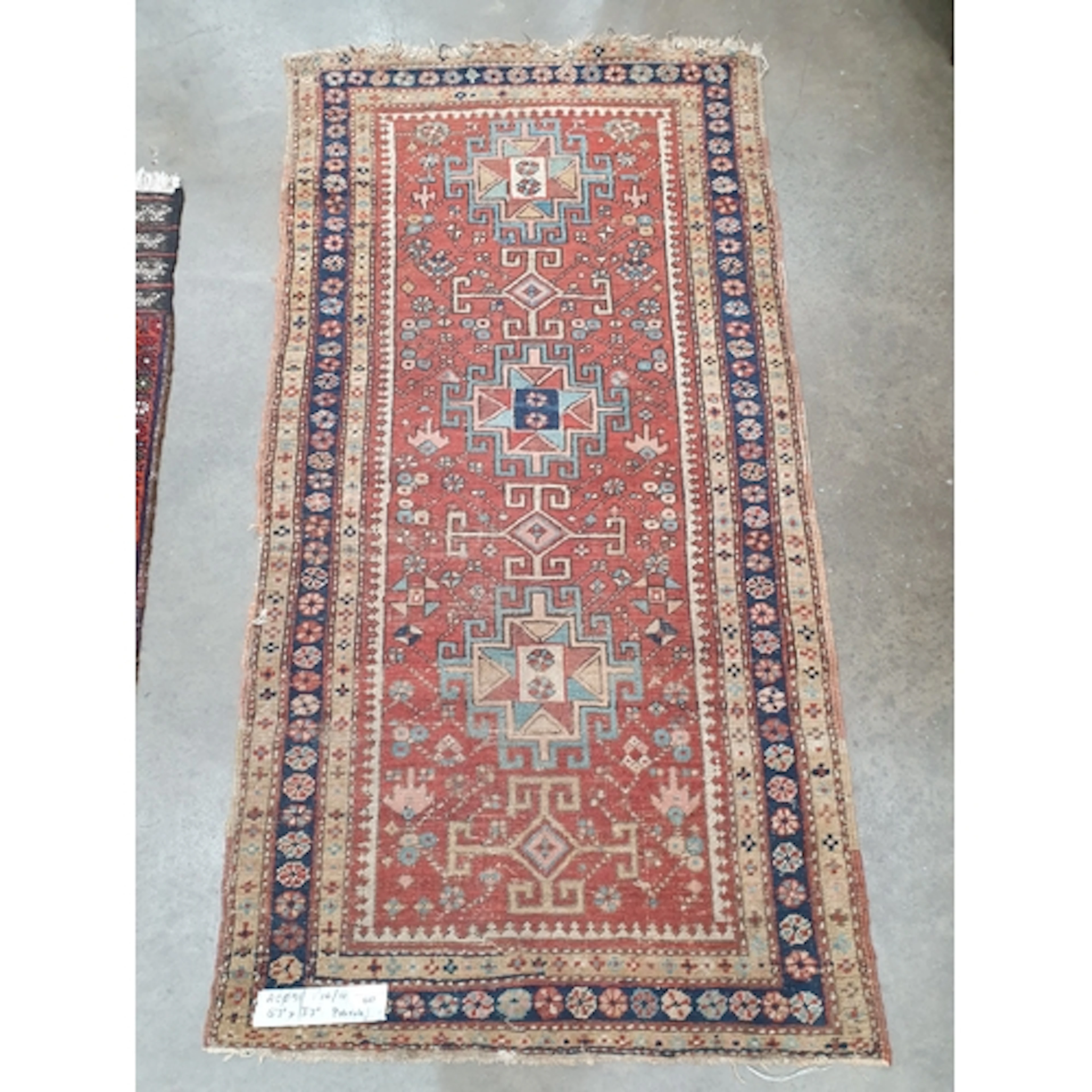 A Rug on beige and orange ground with multiple lozenge desig...