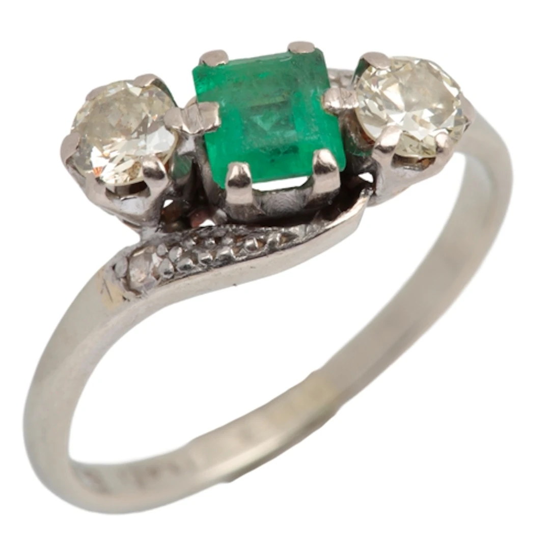 An emerald and diamond ring, early 20th century, claw-set wi...