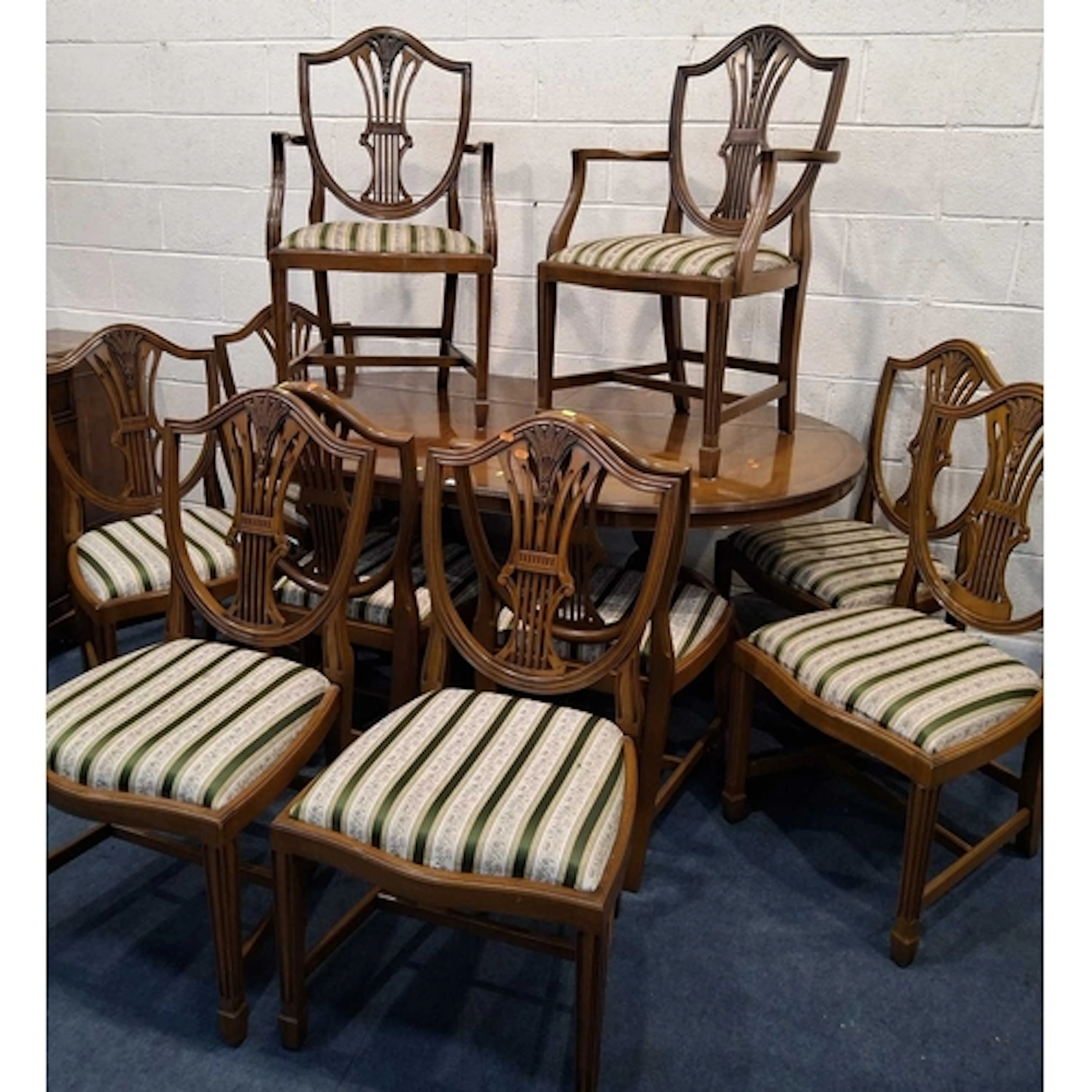 A REPRODUCTION YEW WOOD TWIN PEDESTAL DINING TABLE, two addi...