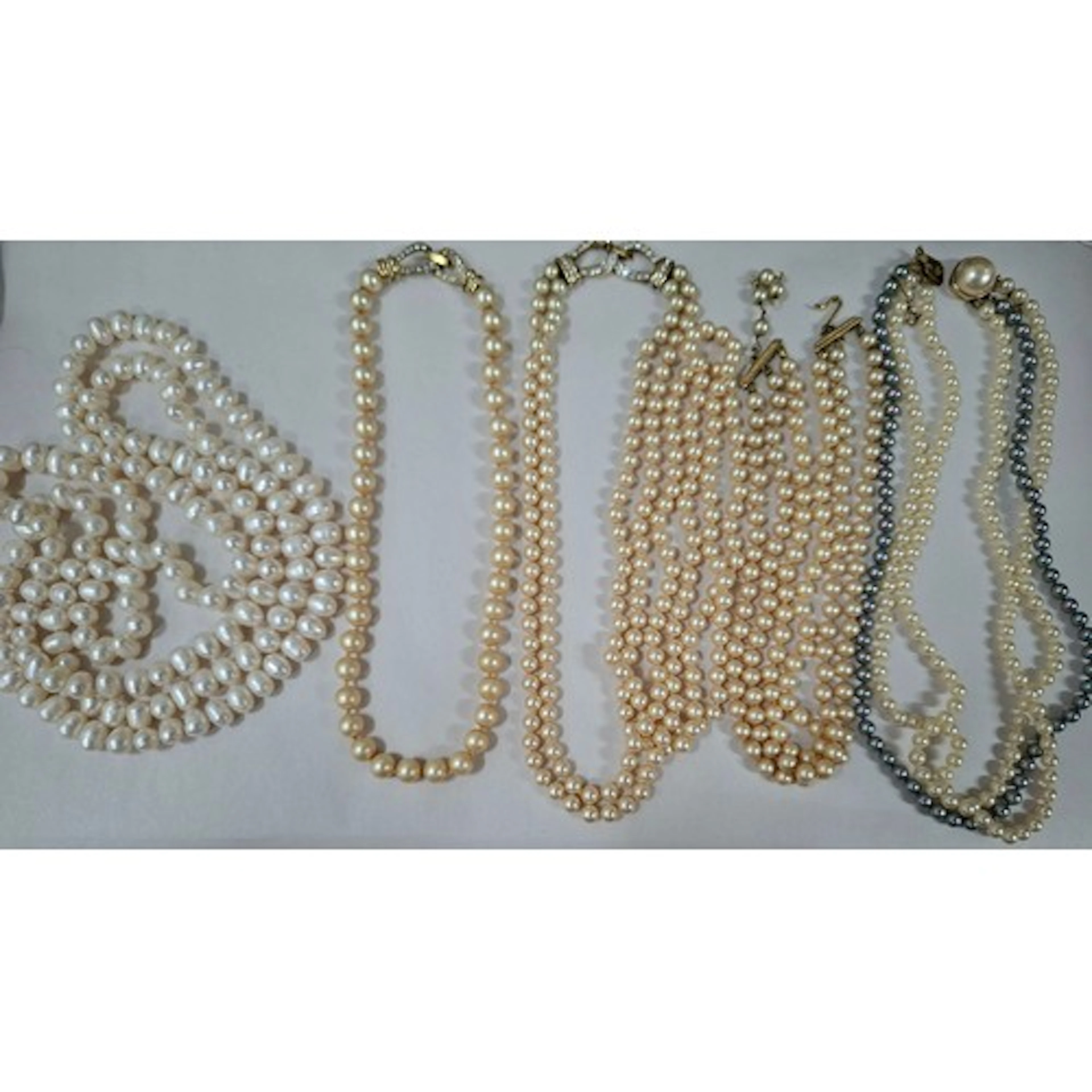 A string of Freshwater pearls 122cm long together with vinta...
