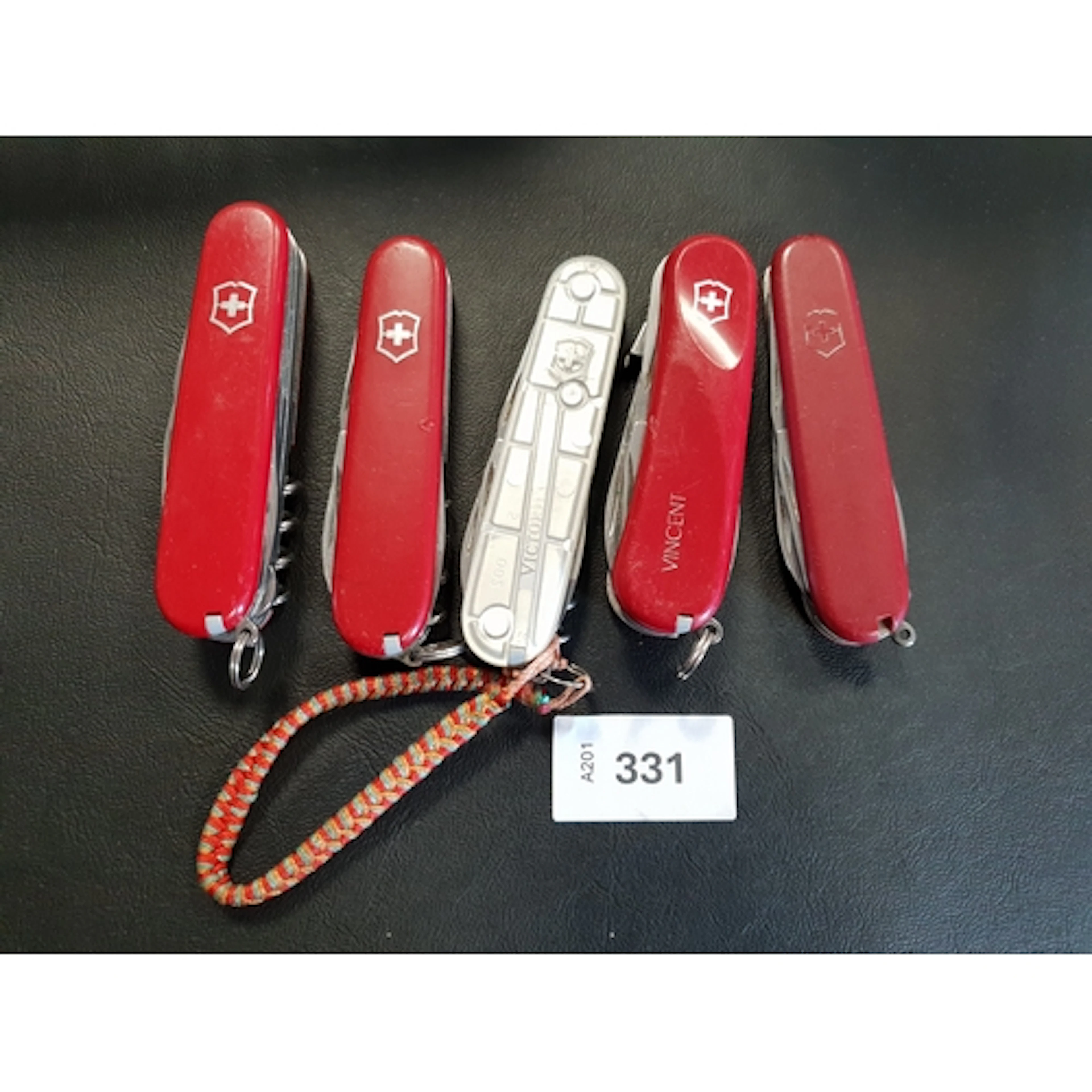 FIVE VICTORINOX SWISS ARMY KNIVES of various sizes and desig...