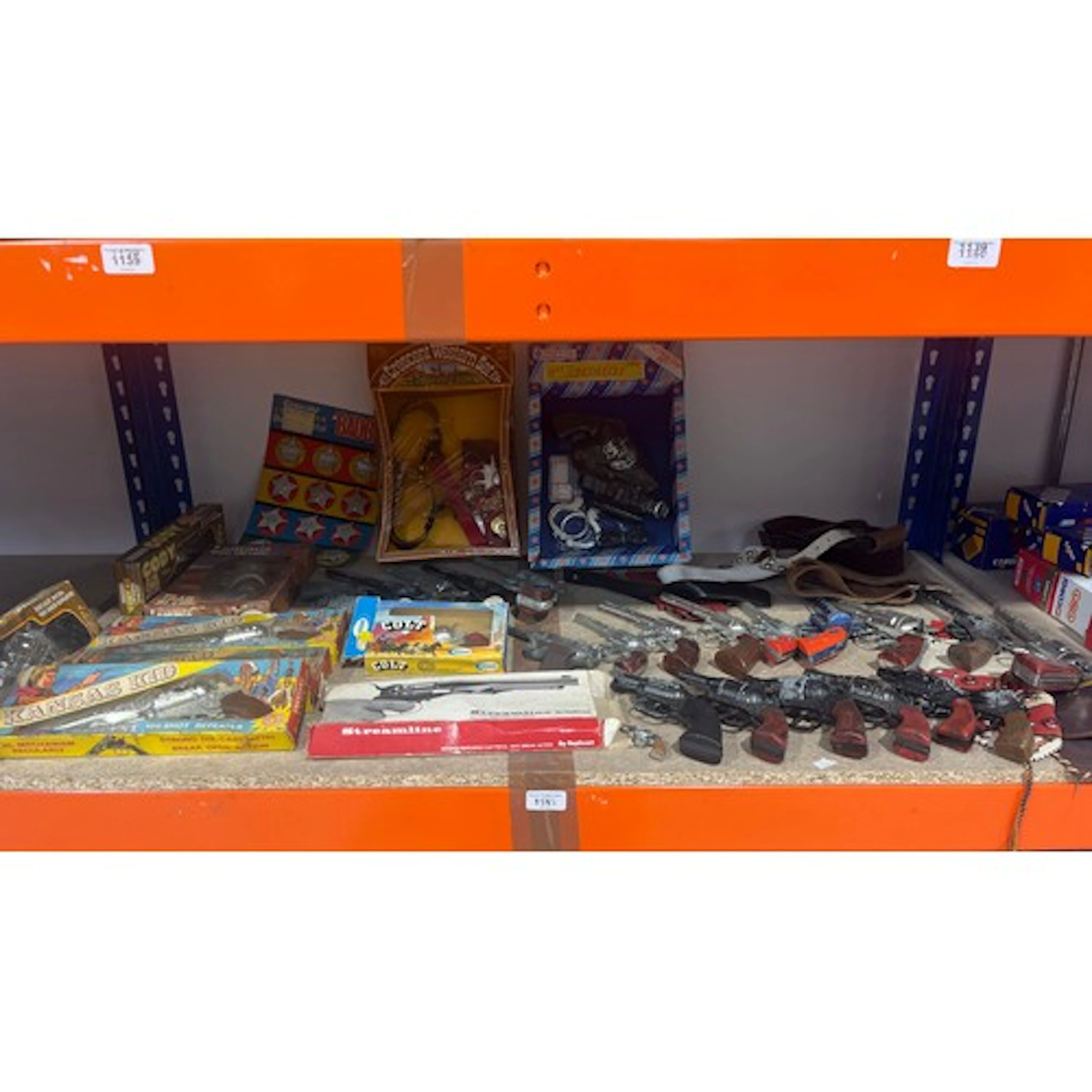 Collection of kids toy cowboy guns, holsters and Sheriff bad...