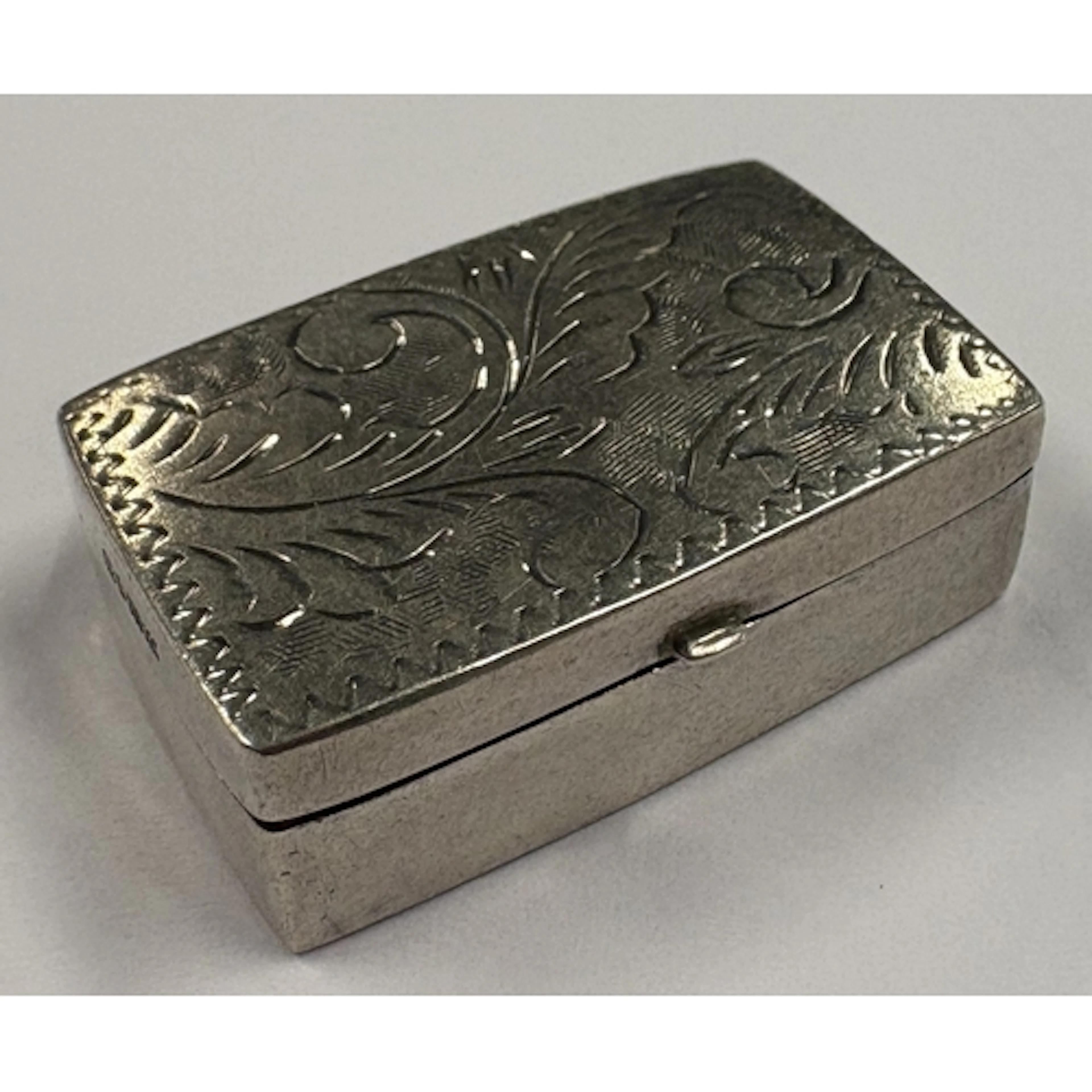 An engraved Sterling silver pill box with hinged cover, mark...