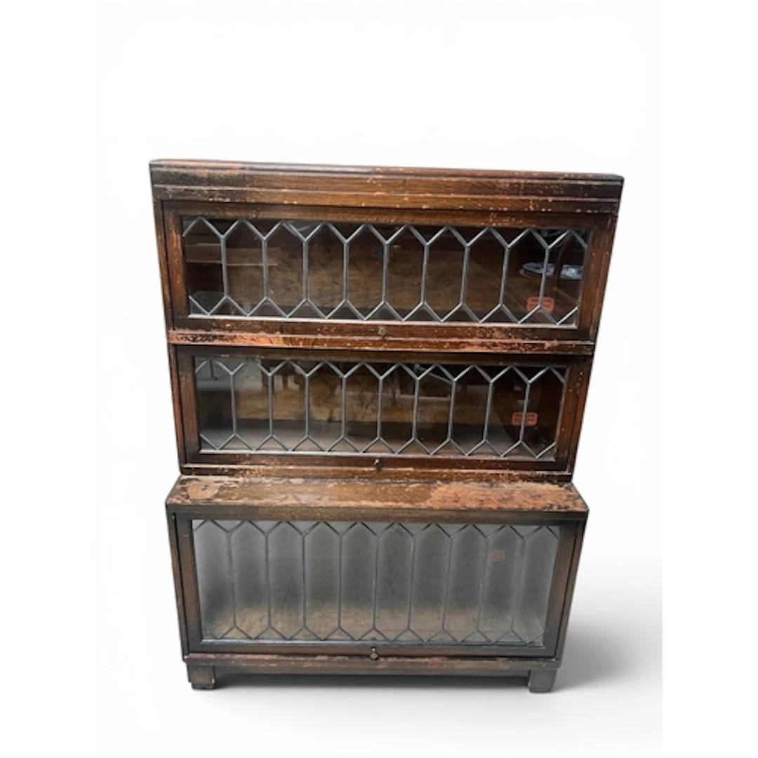 AN OAK THREE TIER STACKING BOOKCASE Enclosed by glazed up an...