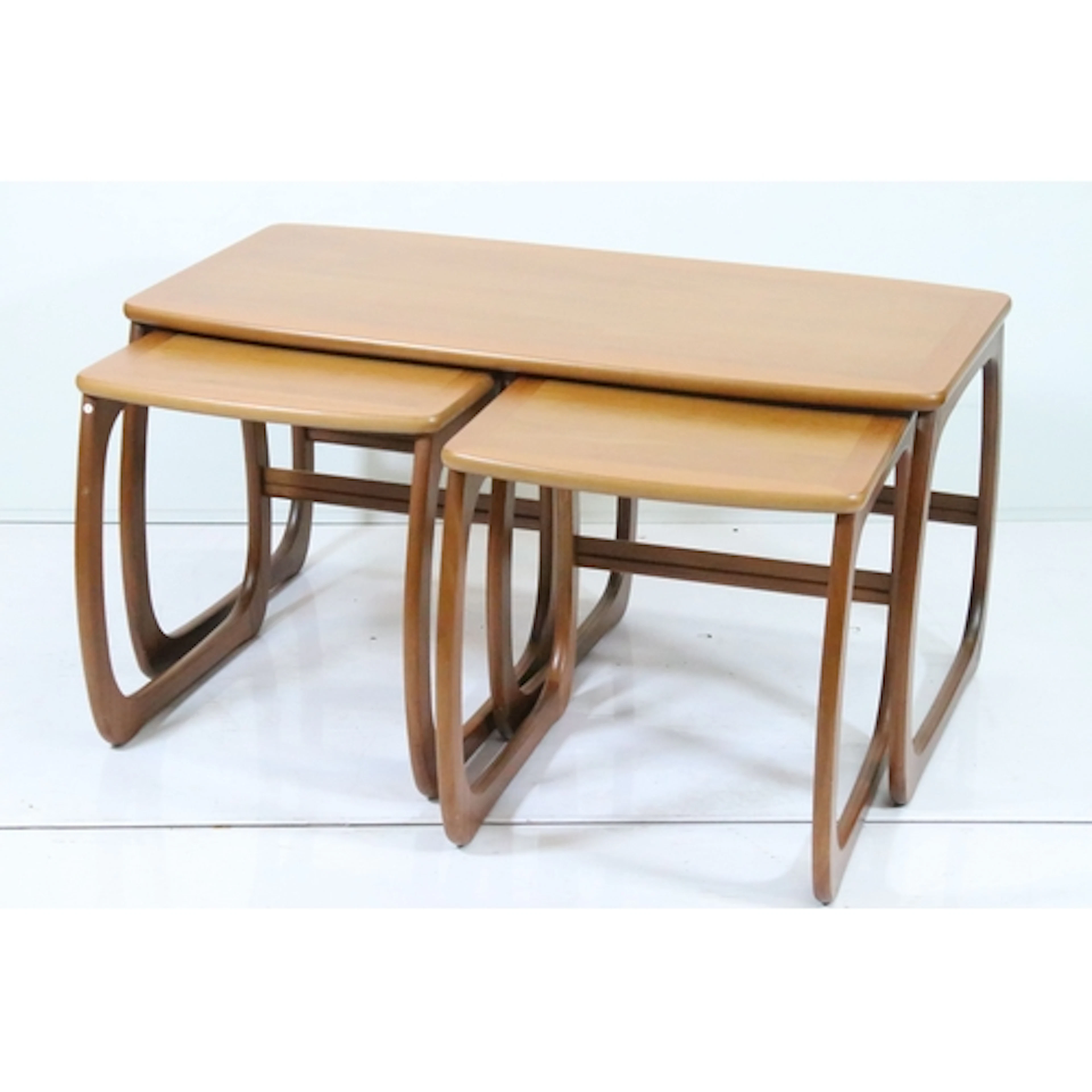 Nest of three mid 20th century tables, the largest having ro...