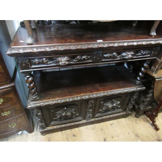 Victorian carved oak buffet, the pierced back above two mask...