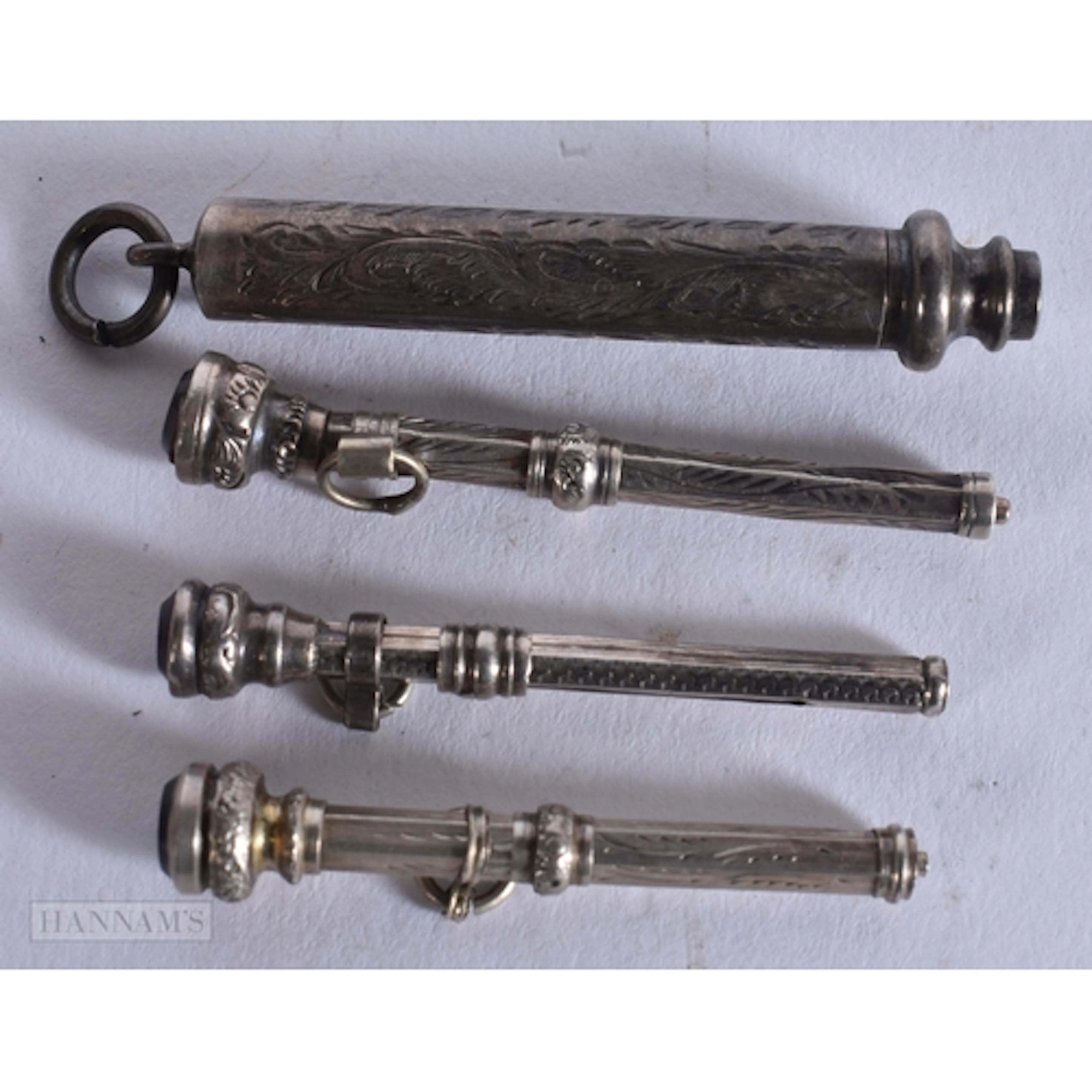 FOUR MINIATURE ANTIQUE SILVER FOB PENS/PENCILS. (4)